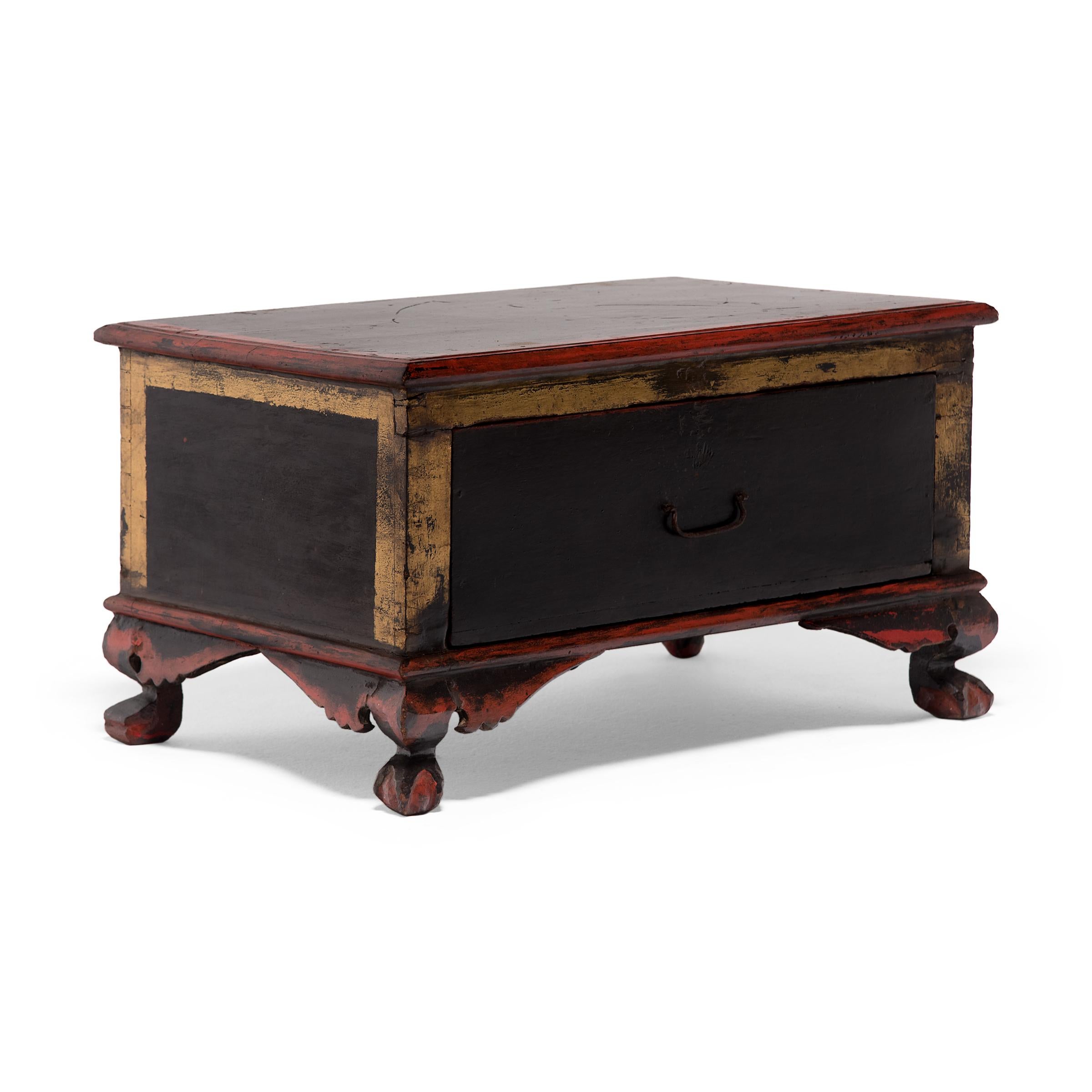 Coat upon coat of red, black and yellow lacquer was hand-applied to this 19th-century footed trunk likely originated as a display stand and storage chest in an elaborate shrine display. Placed to the side of the altar, the chest may have held