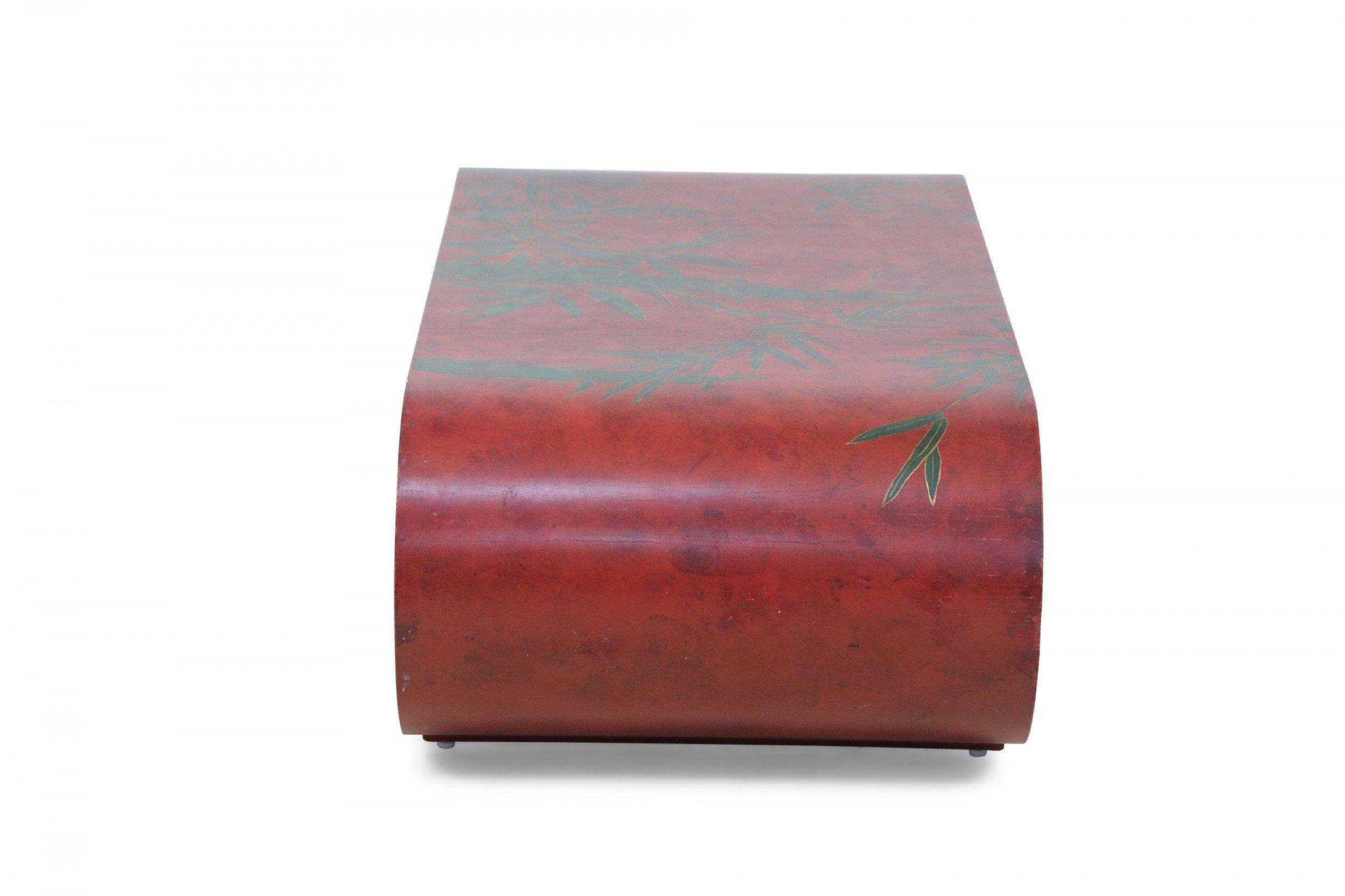 Chinese red lacquered, low scroll side coffee table painted with a muted green bamboo leaf motif, outlined in gold across the surface.