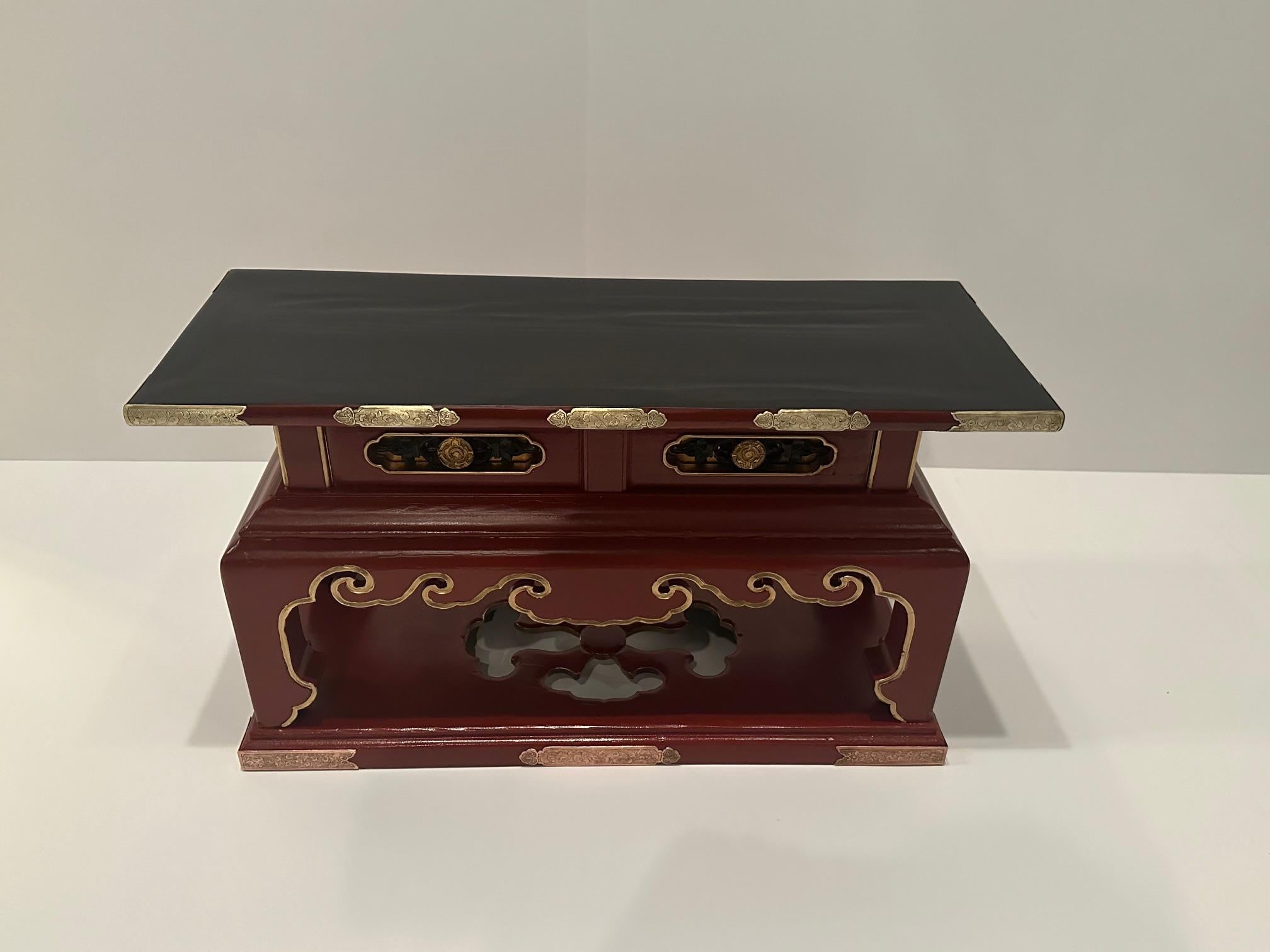 Striking black and red laquered Chinese vintage altar table having beautiful brass and copper accents and wonderful shape with one drawer,  Makes a fabulous accent table.