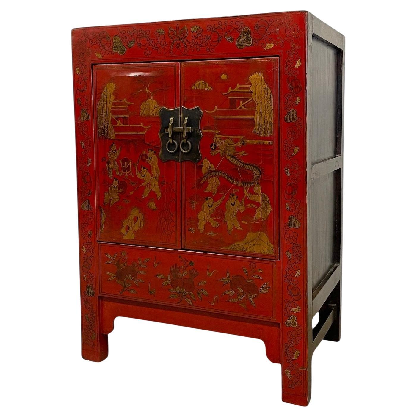 Chinese Red Cabinet with Gilt Figural and Dragon Motifs For Sale