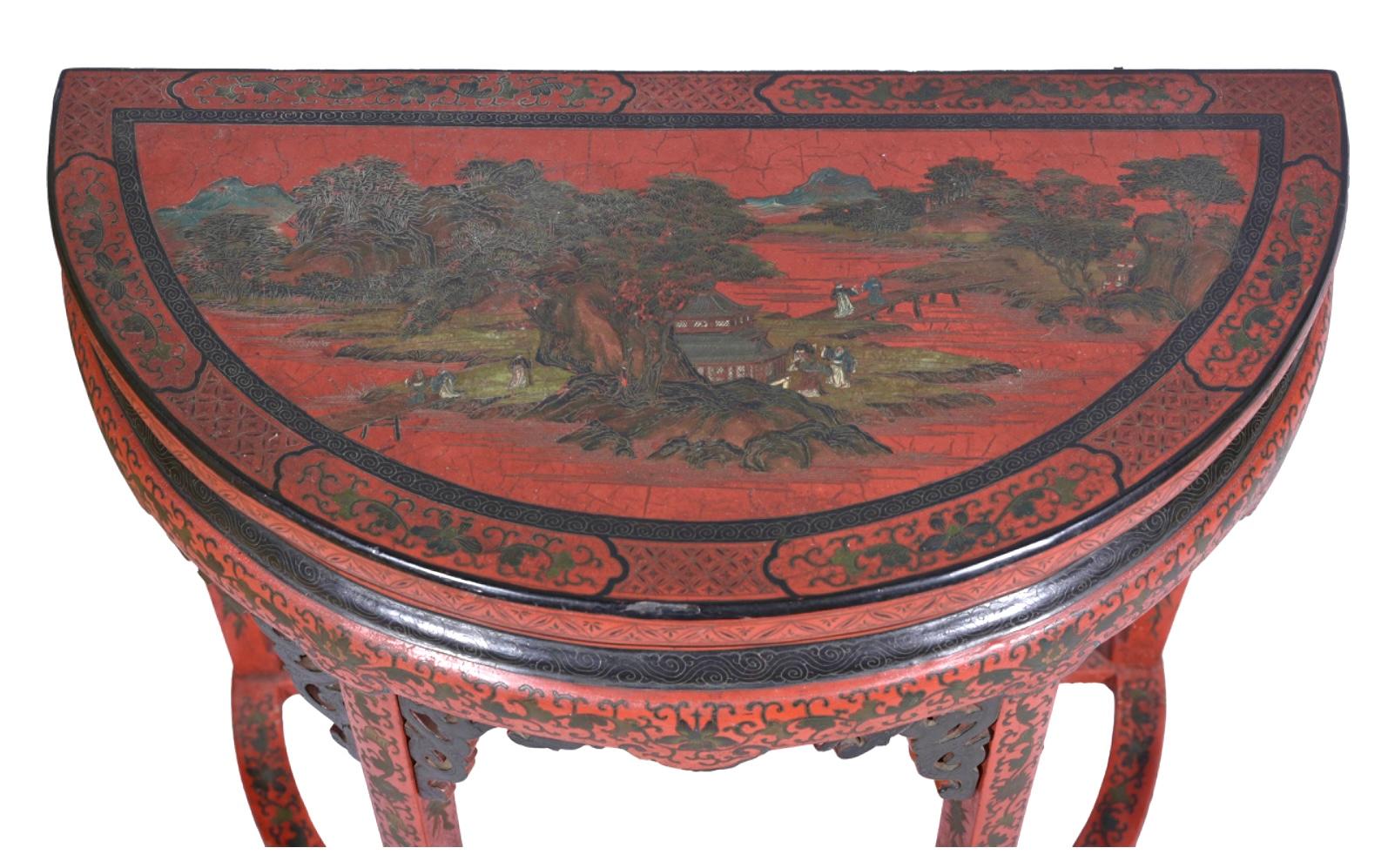 19th century Chinese red chinoiserie demilune console table with hand-painted Asian scenes of trees, houses and Chinese characters in olive and black on red colors. Legs and top are decorated with black scrolling. Table is versatile enough to be