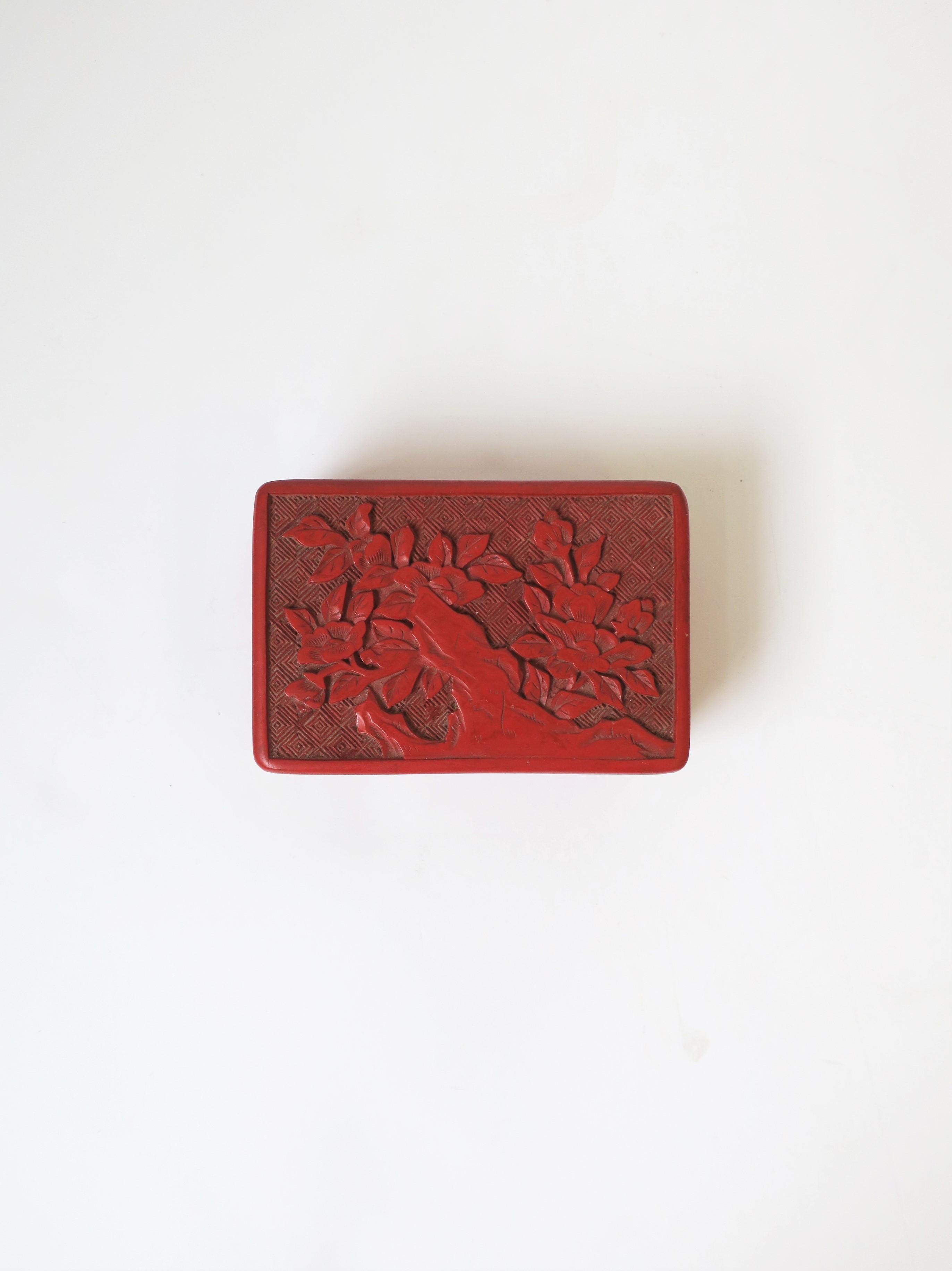 A beautiful Chinese red cinnabar box with a tree and leave design, black lacquer interior and bottom, circa 20th century China. Dimensions: 2.75