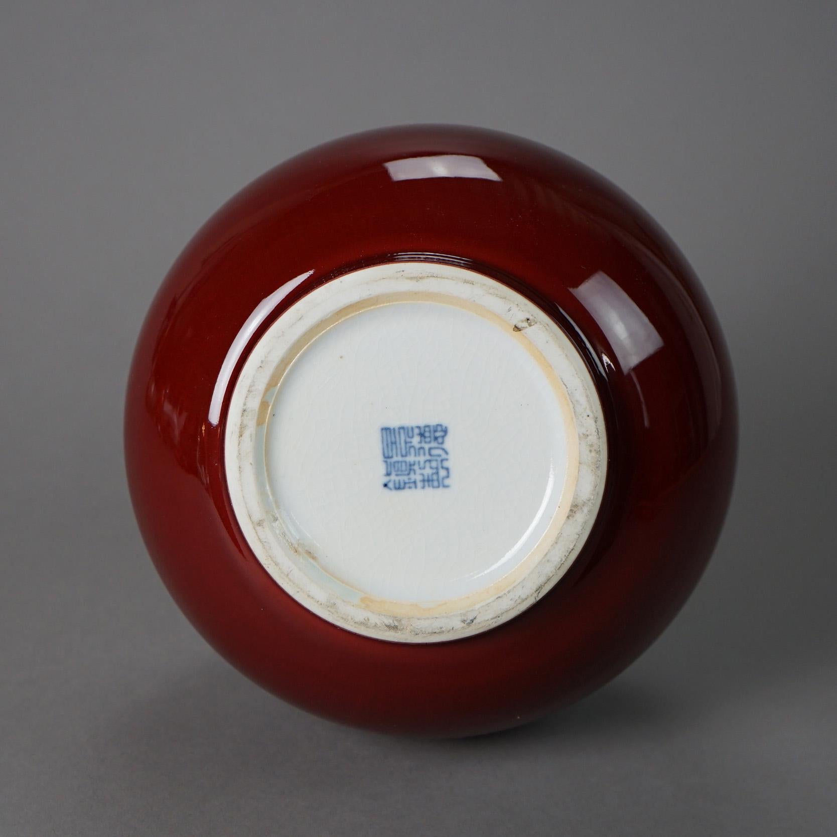A Chinese vase offers pottery construction in bottle form with Red Flambé glaze and stamp on bottom as photographed, 20th century

Measures - 13