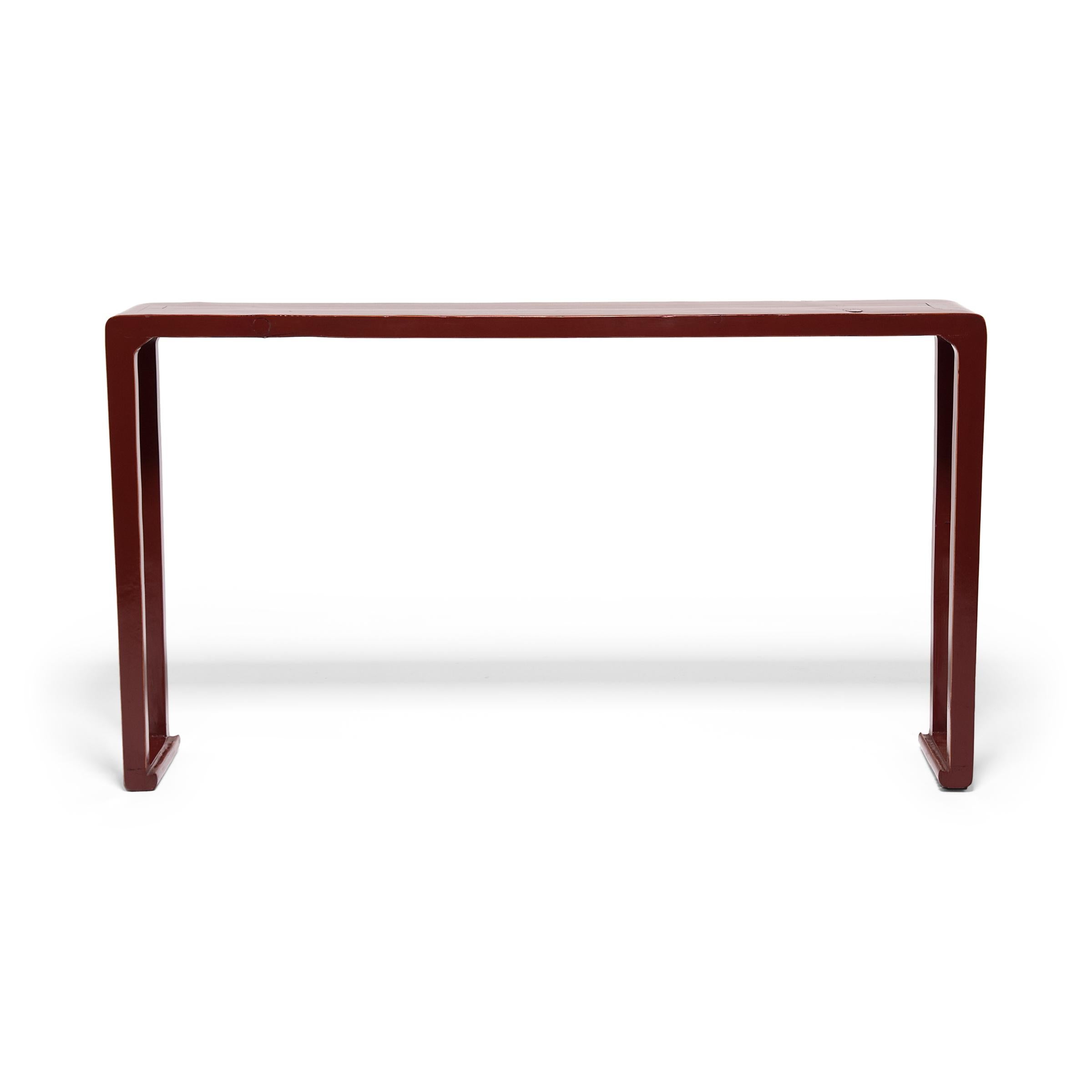 This 19th century altar table from northern China has a minimal form cloaked in layer upon layer of brilliant red lacquer. Tinted red with the addition of cinnabar, lacquer enhances with glossy color and protects the wood beneath from water and heat