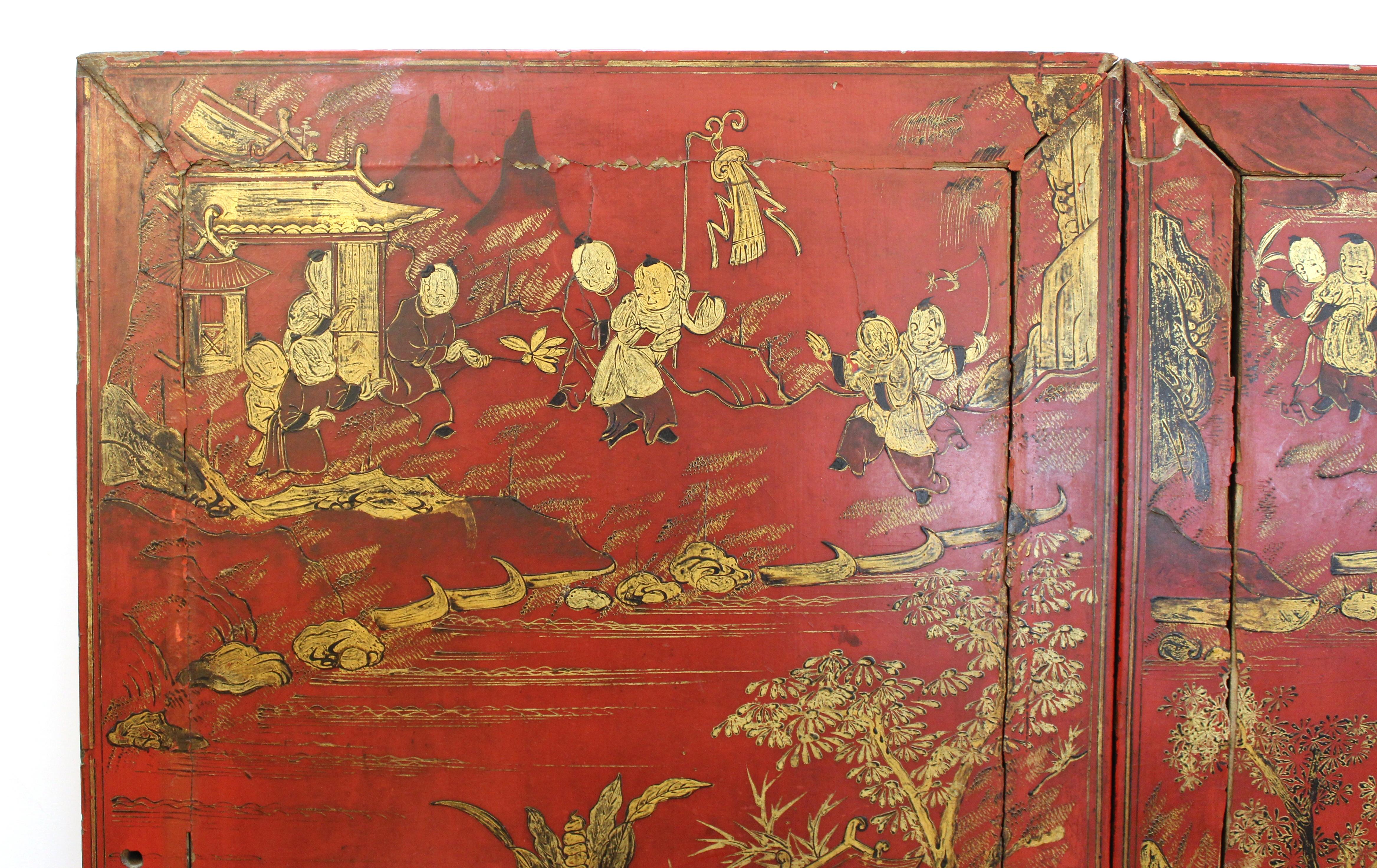 Chinese late 19th century red lacquered door panels with gilt decor depicting landscapes with architecture and young boys playing. The panels likely came from a cabinet and are mounted together to be hung as decorative wall element.