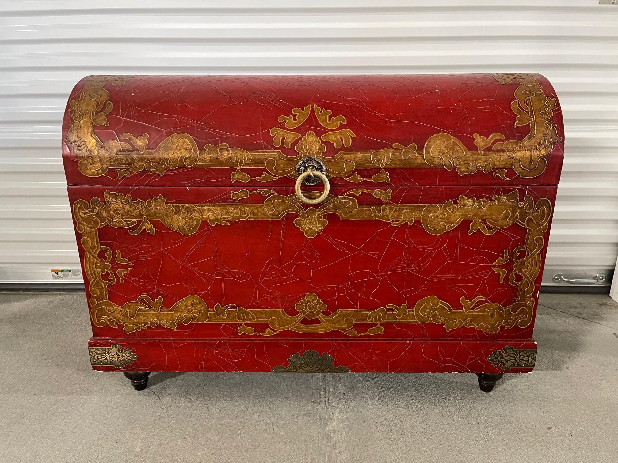 Chinese red lacquer and gold detailing dome top trunk on feet, 20th century.