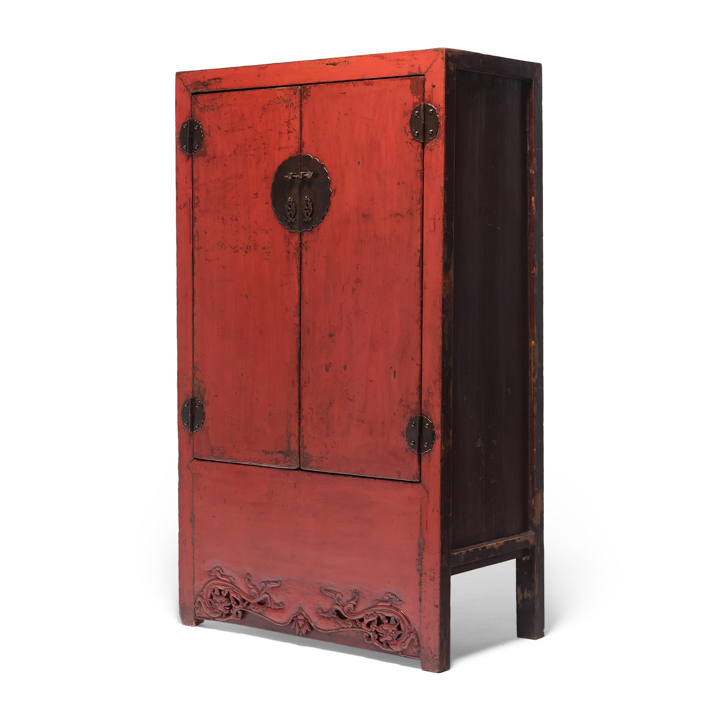 Slightly shorter than most upright Chinese cabinets, this red lacquer cabinet charms with its modest scale and perfect proportions. Dated to the mid-19th century, the cabinet is crafted of northern elmwood (yumu) and brushed on all sides with richly