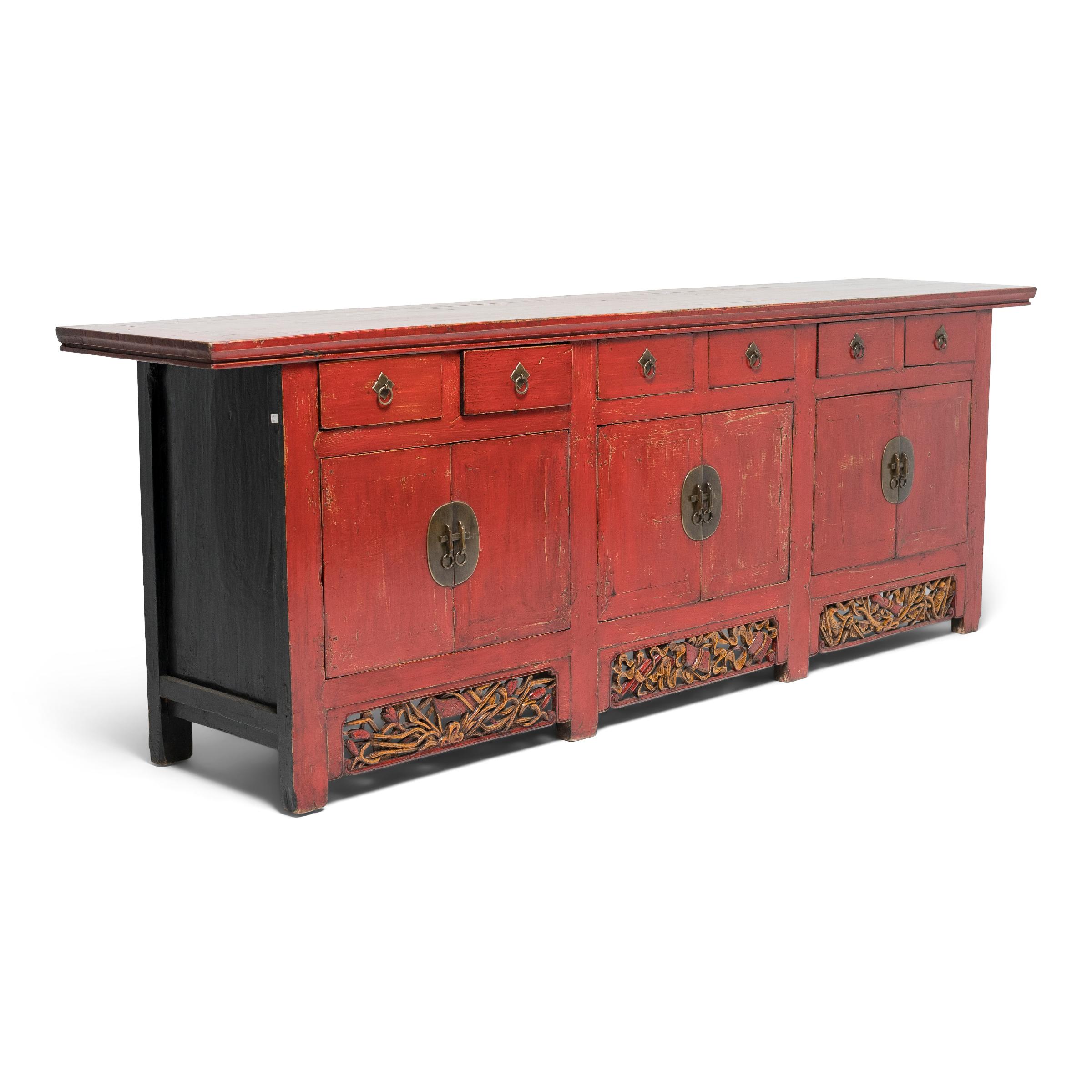 Dated to the late 19th century, this vibrant red coffer was likely used as both an altar for ancestor worship and as a storage cabinet for clothes, textiles, and other household items. The large coffer is crafted of northern elm with straight sides,