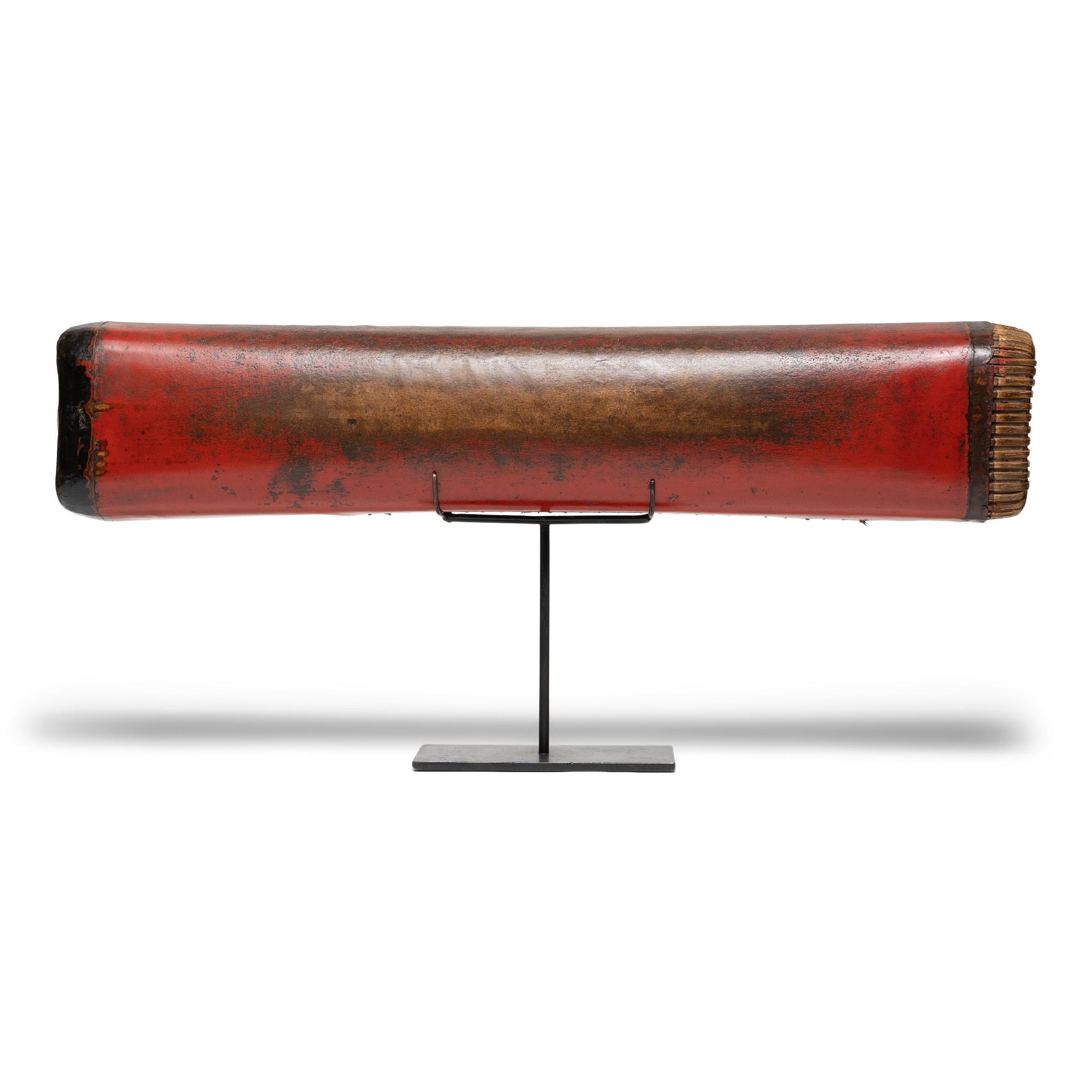 This extraordinary Chinese headrest from the late Qing dynasty is hand-crafted of lacquered hide atop an elongated bamboo frame. Used while sleeping like a modern pillow, the headrest has a pliable design that enabled contour comfort - quite