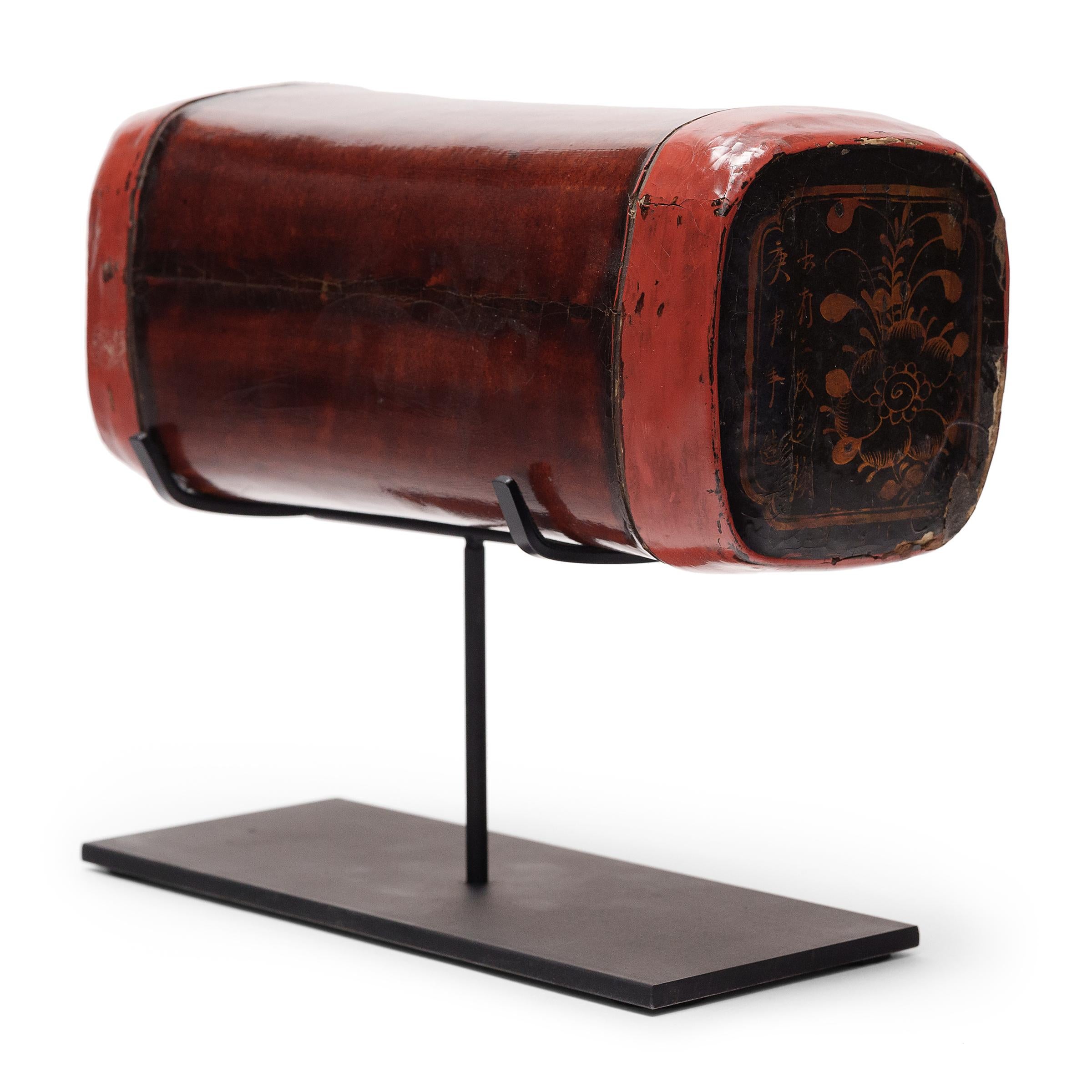 Dated to the late 19th century, this fine Chinese headrest is hand-crafted of lacquered hide atop an elongated bamboo frame. Used while sleeping like a modern pillow, the headrest has a pliable design that enabled contour comfort - quite luxurious