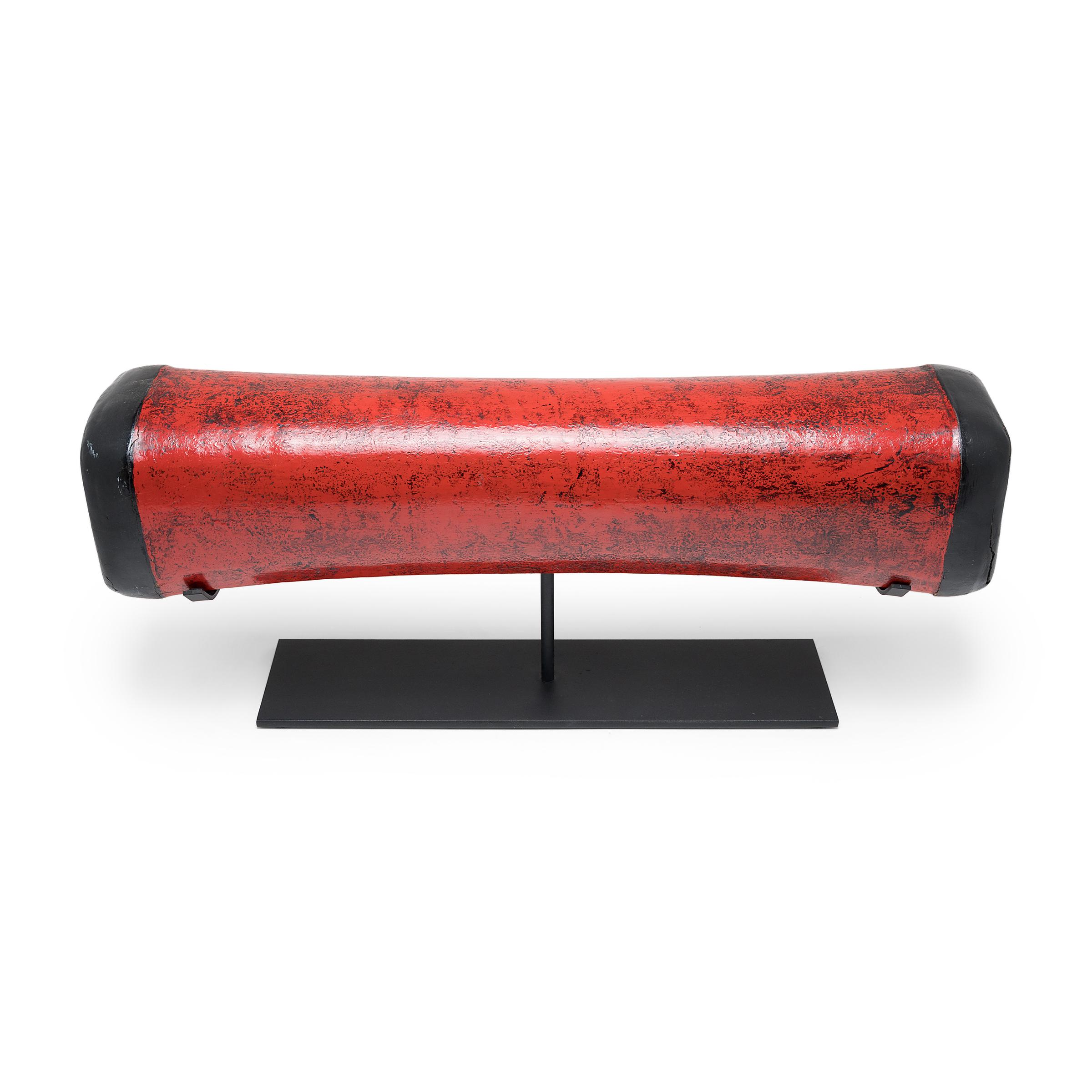Dated to the late 19th century, this extraordinary Chinese headrest is hand-crafted of lacquered hide atop an elongated bamboo frame. Used while sleeping like a modern pillow, the headrest has a pliable design that enabled contour comfort - quite