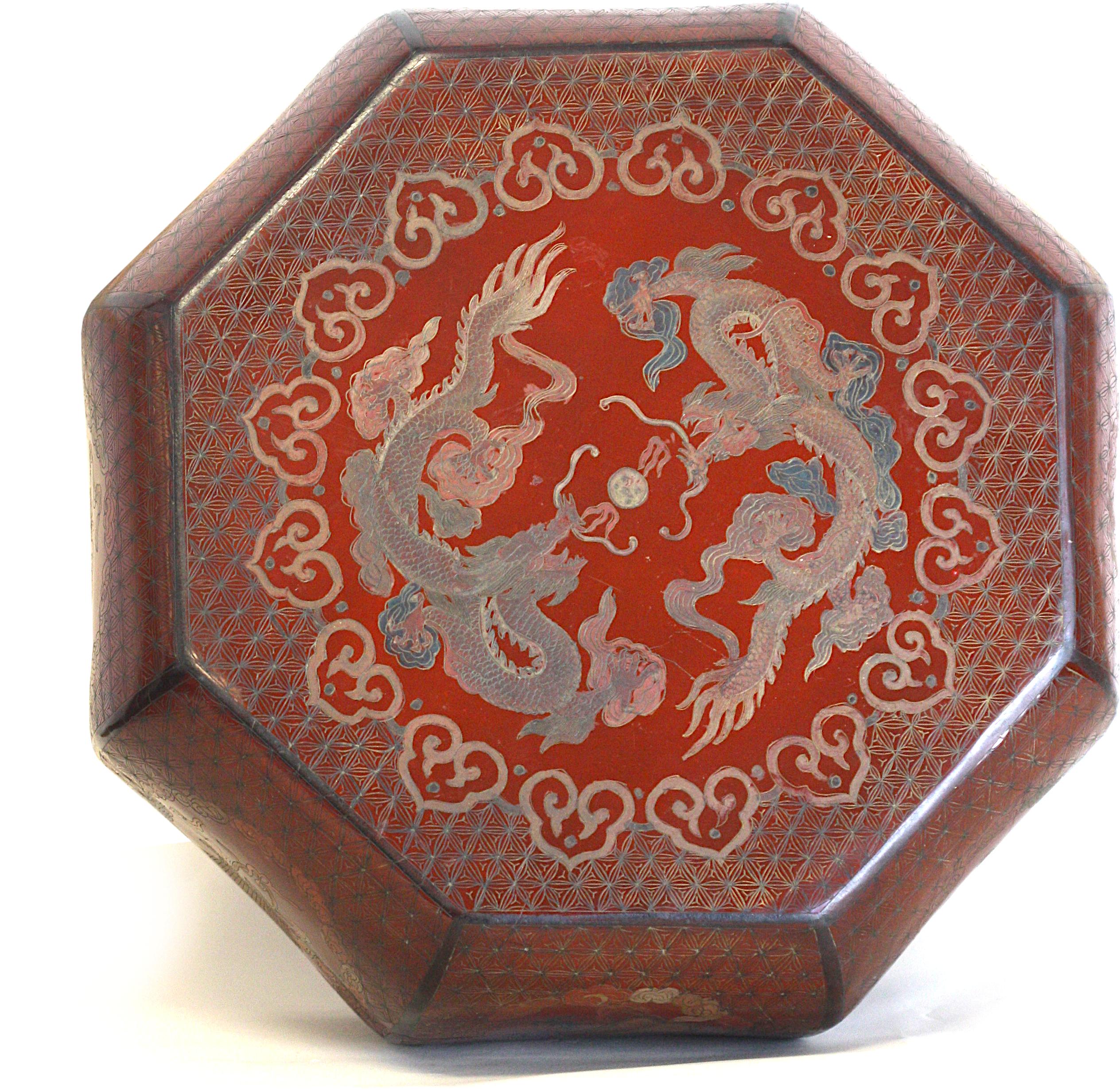 
Chinese Red Lacquer Octagonal Box
The top is decorated with dragons, each side with an auspicious symbol.
Height 7.5 in. (19.05 cm.), Diameter 17 in. (43.18 cm.)