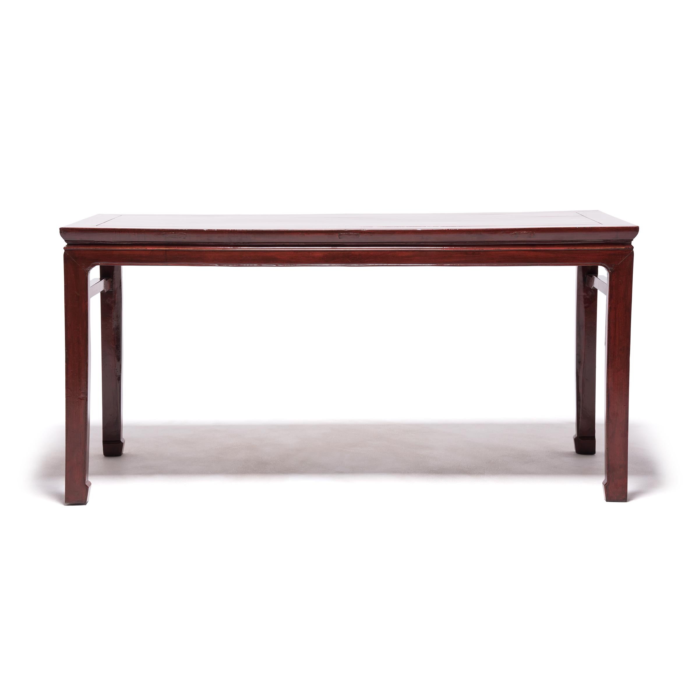 This elegant elmwood painting table was crafted over a century ago by artisans in northern China. The broad tabletop provided an ideal surface for unfurling a scroll to compose poetry or calligraphy paintings. The table is beautifully proportioned
