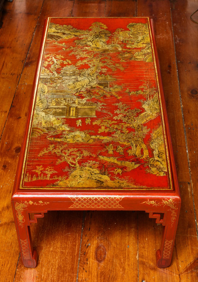 Fine Qianlong red lacquer panel with gold decoration of court figures in a landscape, now mounted as a coffee table.