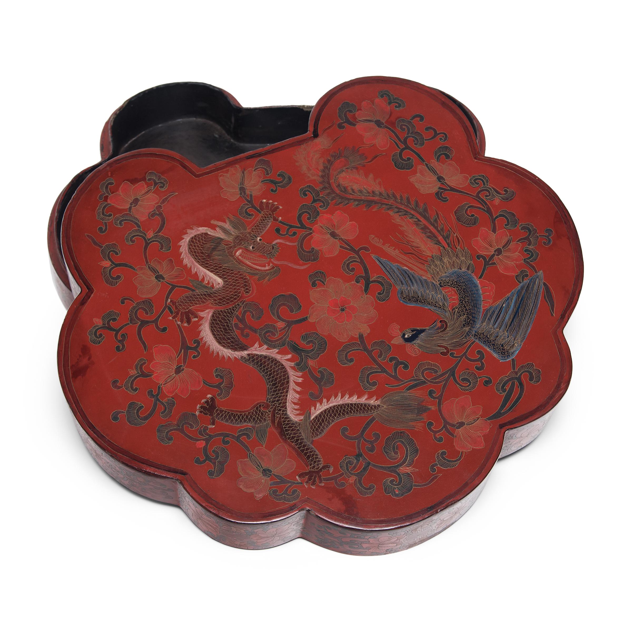 This finely lacquered box was once presented as a gift, filled with popular snacks like roasted melon seeds, dried fruit, and cinnamon-toasted soy beans. The lightweight box is formed in the shape of a ruyi scepter, a symbol of prosperity and a