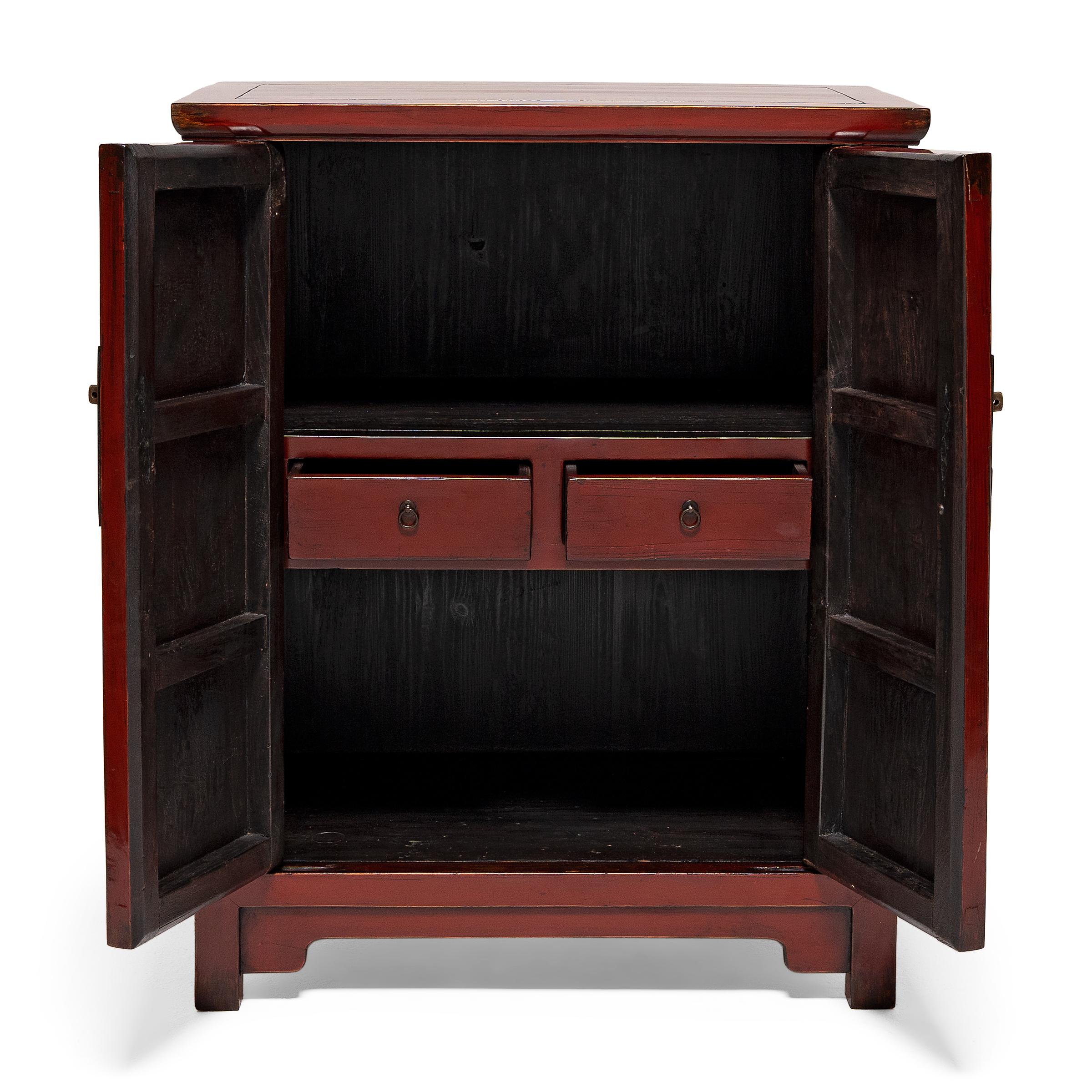 A slightly smaller version of traditional tall cabinets, this red lacquer chest honors the clean lines and balanced proportions of classic Chinese furniture design. Originally used for books, scrolls, and general storage, the chest is crafted in the