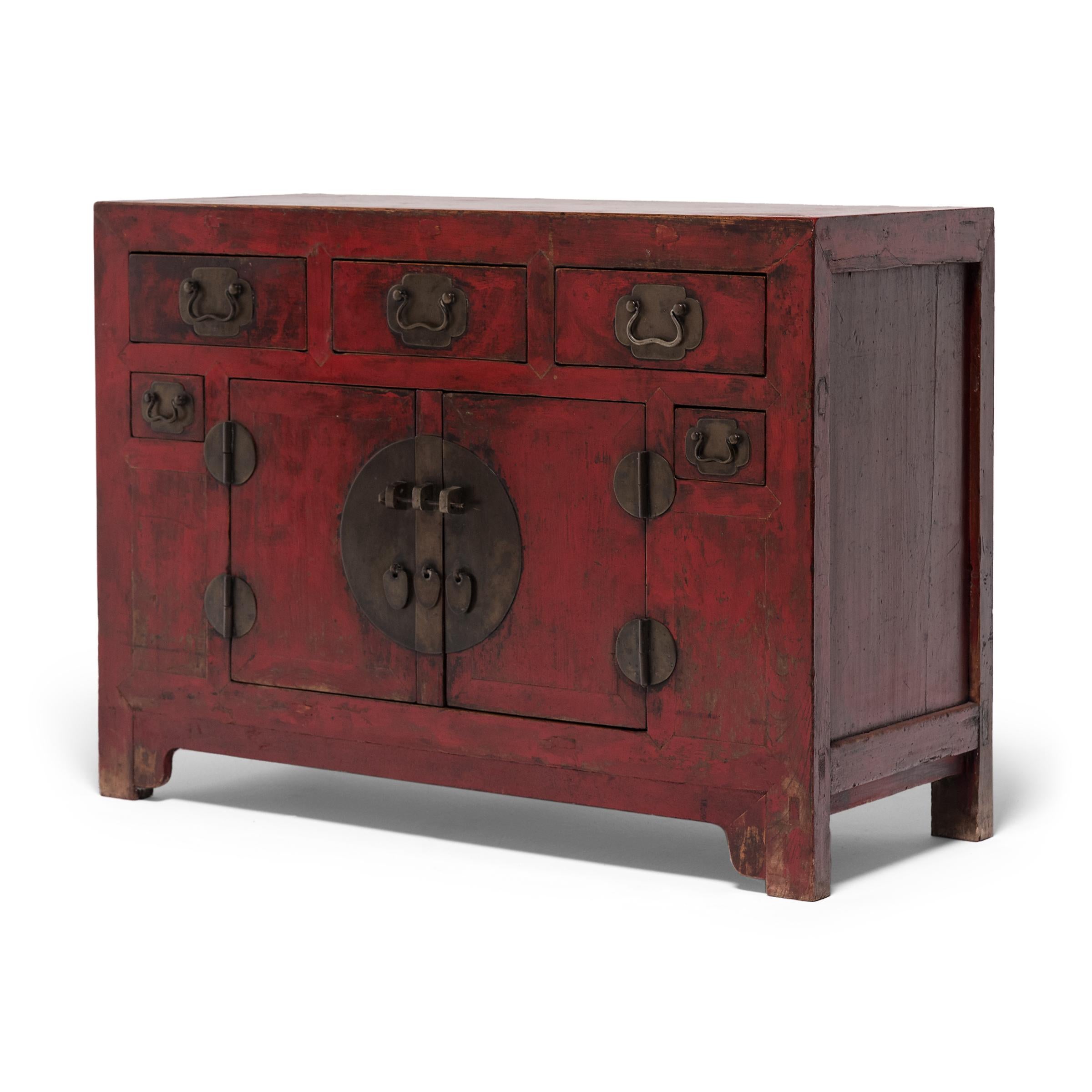 This gorgeous red lacquer coffer beautifully represents the distinctive cabinetry of Tianjin, a port city in northern China. Dated to the mid-19th century, the square-corner cabinet features five drawers and a large lower compartment fitted with an