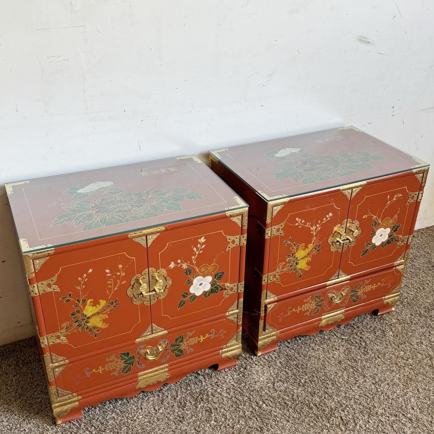 Enhance your bedroom with the Asian elegance of these Chinese Red Lacquered and Hand Painted Glass Top Nightstands with Gold Accents. These vibrant red lacquered nightstands symbolize prosperity and are adorned with traditional Chinese motifs,