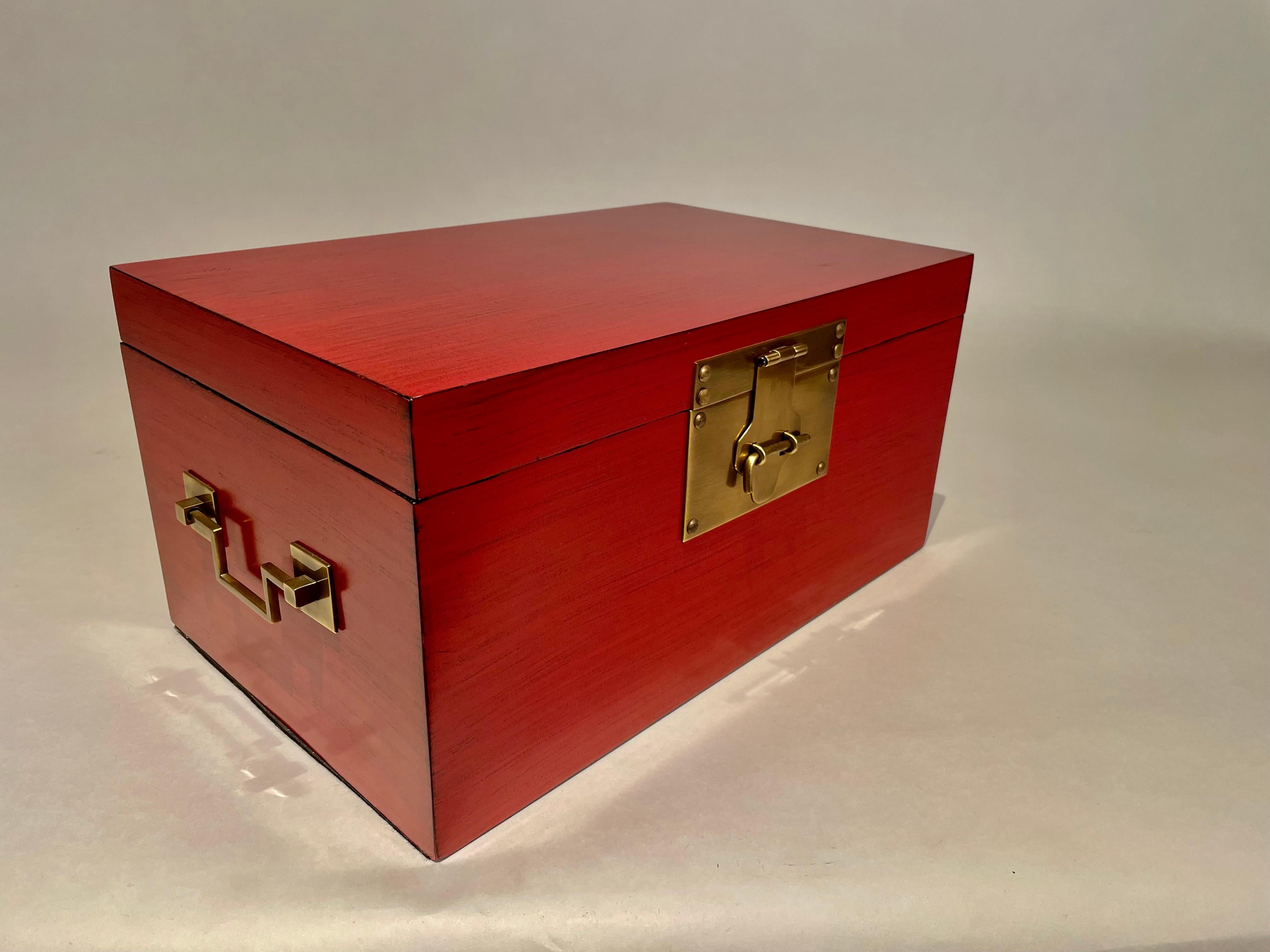 Chinese red and black lacquered box with fine brass mounts in the Chinese Export style. Lovely color. A refined and classic decorative box, beautiful craftsmanship. 
16 inches wide, 10 deep 8 high
We also have a larger companion box, they look great