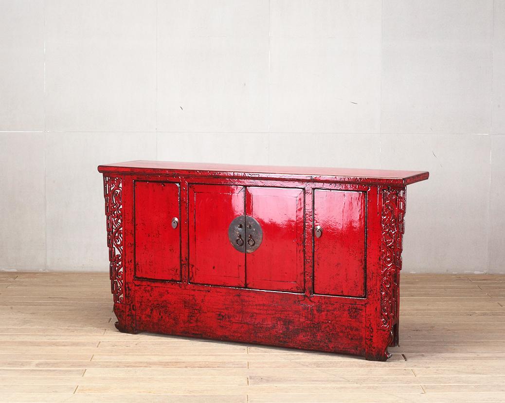 This red-lacquered Chinese cabinet was made from reclaimed pine wood with traditional nail-less joinery. The red lacquer has been enhanced with a sophisticated French polish finish. The piece was restored in a workshop using reclaimed wood in China