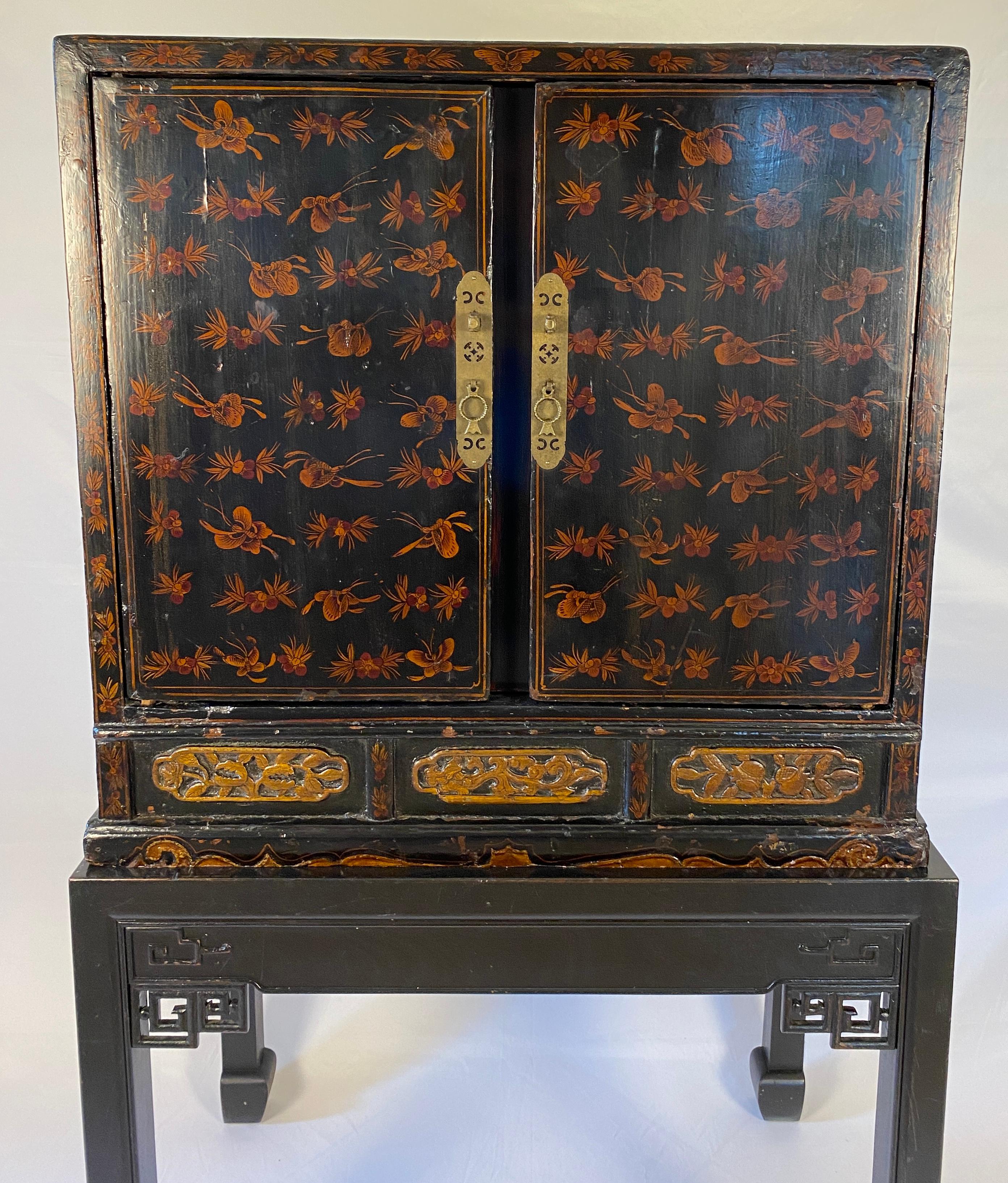A fine quality 19th Century Chinese Red Lacquered Qing Dynasty Cabinet with Chinoiserie Décor. Chinese Dry Bar Cabinet. 

This handcrafted two part Chinese Red Lacquered Qing Dynasty 19th Century Cabinet with Chinoiserie Décor is hand-carved,
