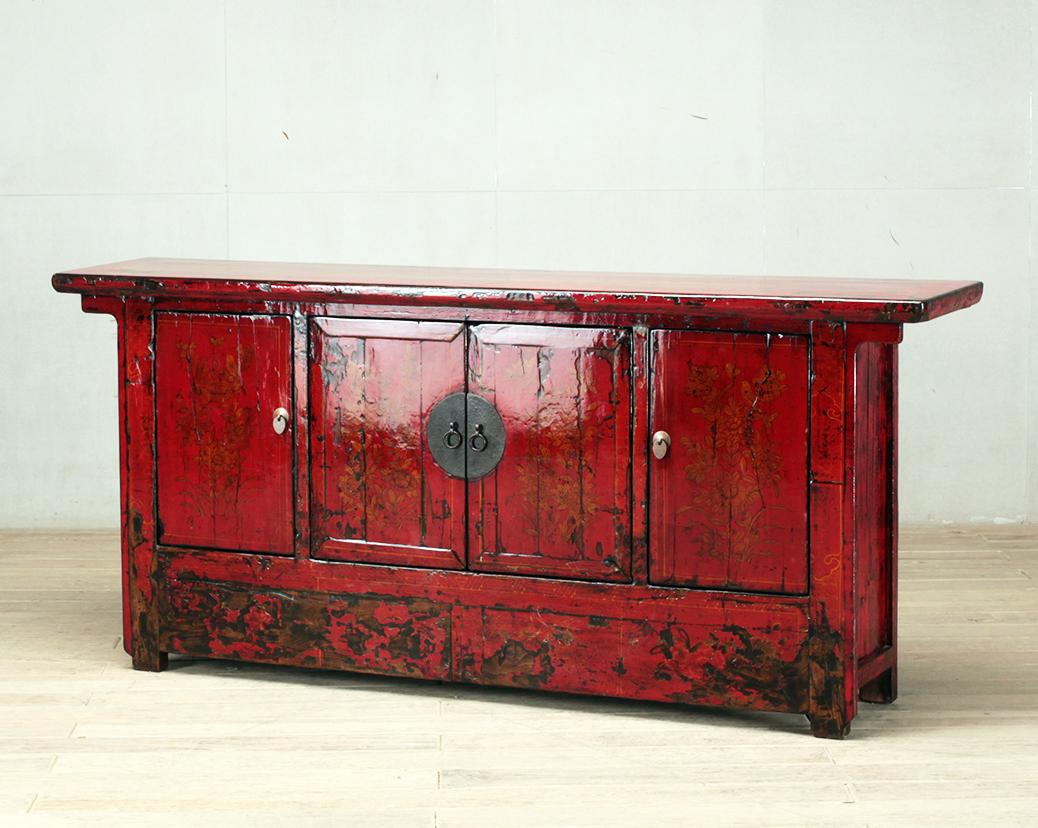 This red-lacquered Chinese sideboard was made from reclaimed pine wood with traditional nail-less joinery. The red lacquer has been enhanced with a sophisticated French polish finish. The piece was restored in a workshop using reclaimed wood in