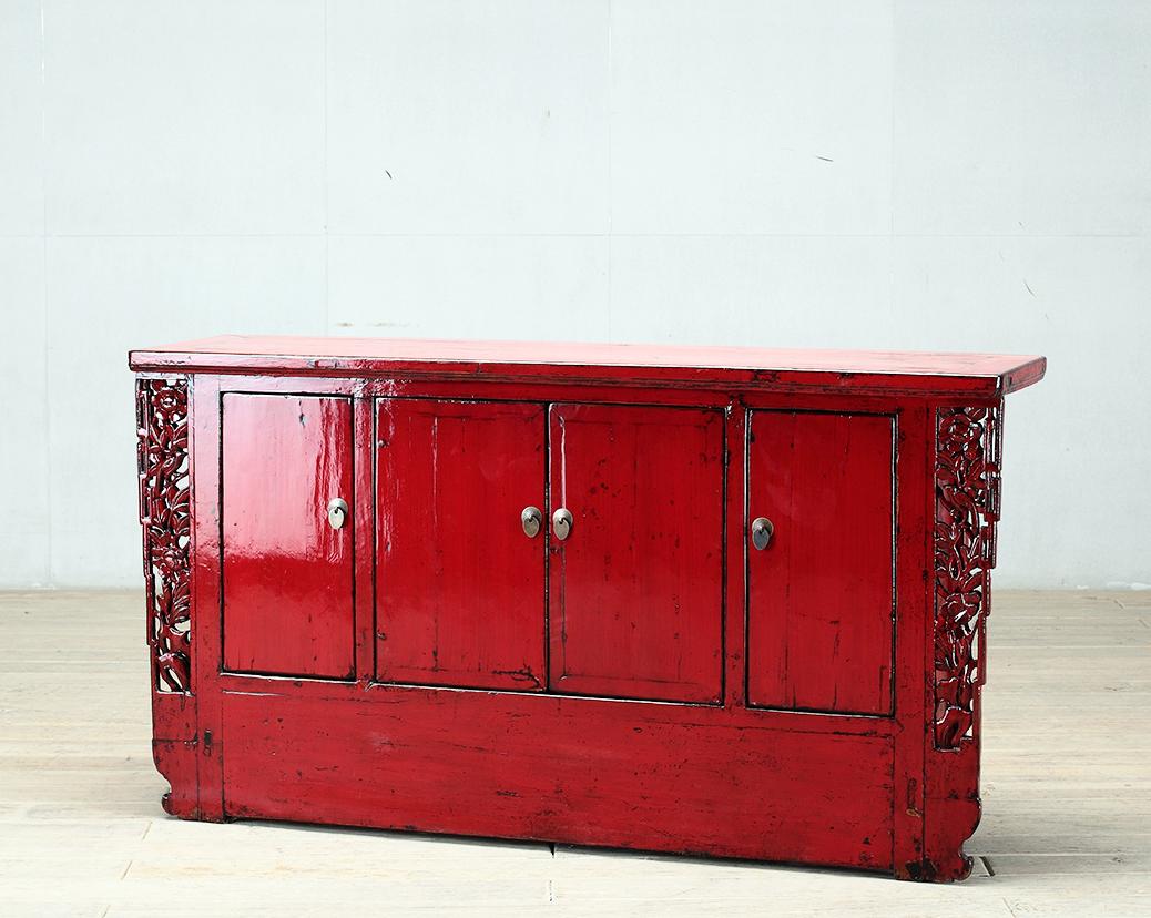 This red-lacquered Chinese sideboard was made from reclaimed pine wood with traditional nail-less joinery. The red lacquer has been enhanced with a sophisticated French polish finish. The piece was restored in a workshop using reclaimed wood in