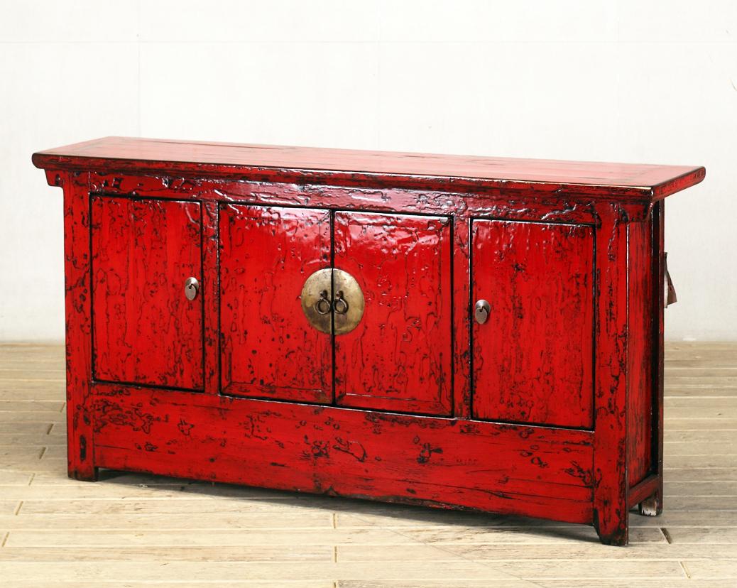 This red-lacquered Chinese sideboard was made from reclaimed pine wood with traditional nail-less joinery. The red lacquer has been enhanced with a sophisticated French polish finish. The piece was restored in a workshop using reclaimed wood in