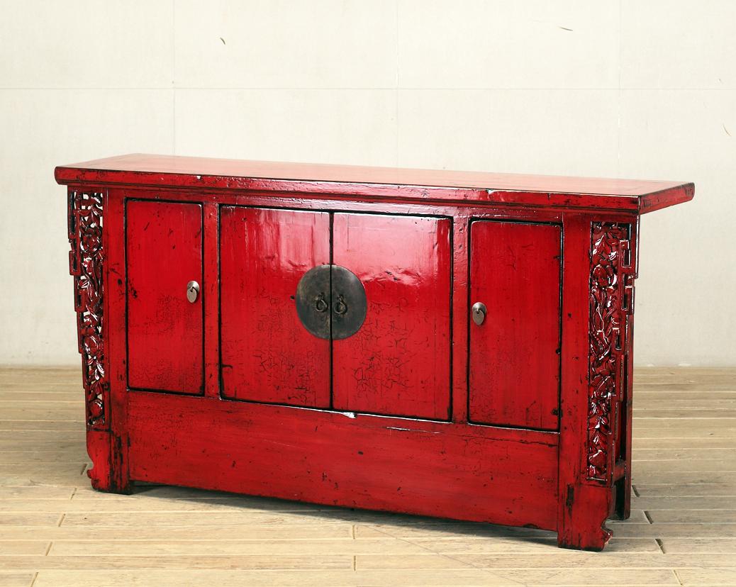 This red-lacquered Chinese sideboard was made from reclaimed pine wood with traditional nail-less joinery. The red-lacquer has been enhanced with a sophisticated French polish finish. The piece was restored in a workshop using reclaimed wood in