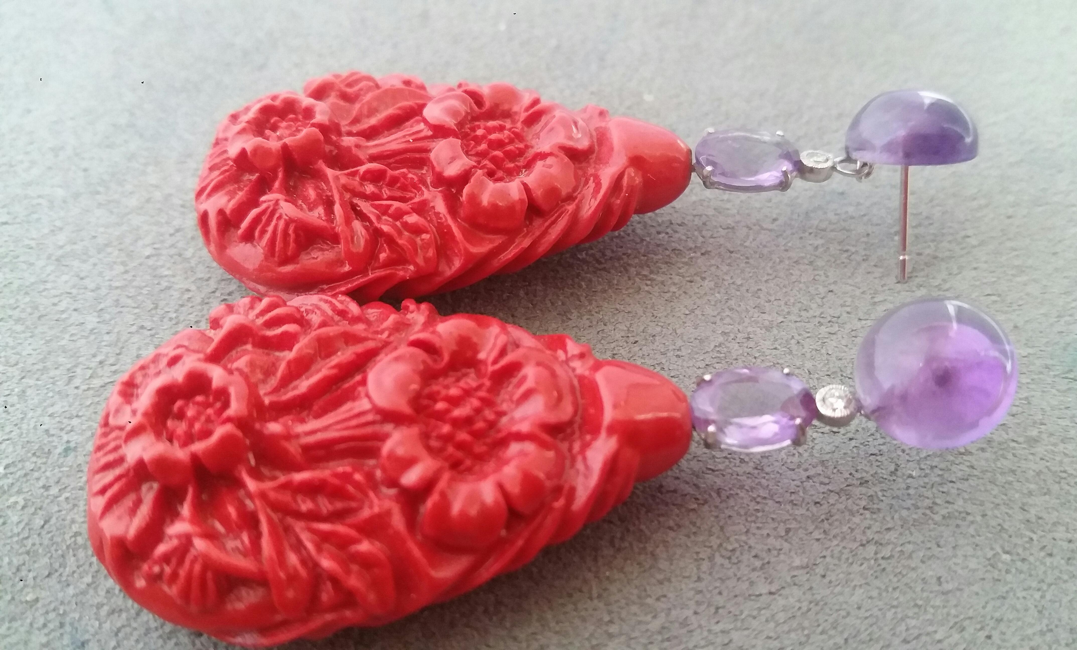 2 round Amethyst cabochons support 2 oval faceted amethysts 8x6 mm and 2 small diamonds then at the bottom we have 2 large drops of Chinese Lacquer  measuring 40 x 25 mm engraved with floral motifs 
In 1978 our workshop started in Italy to make