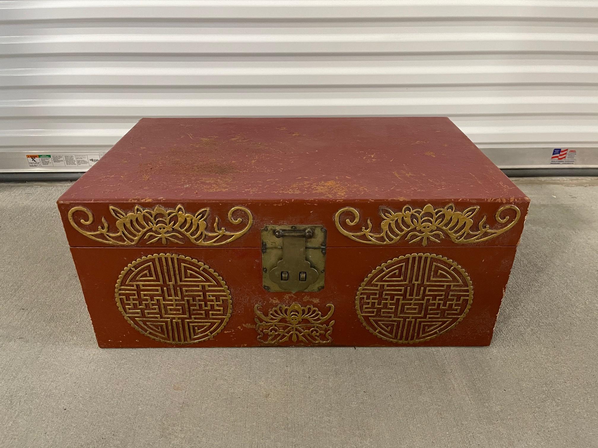 Chinese red leather trunk with brass lock and handles, 20th century.