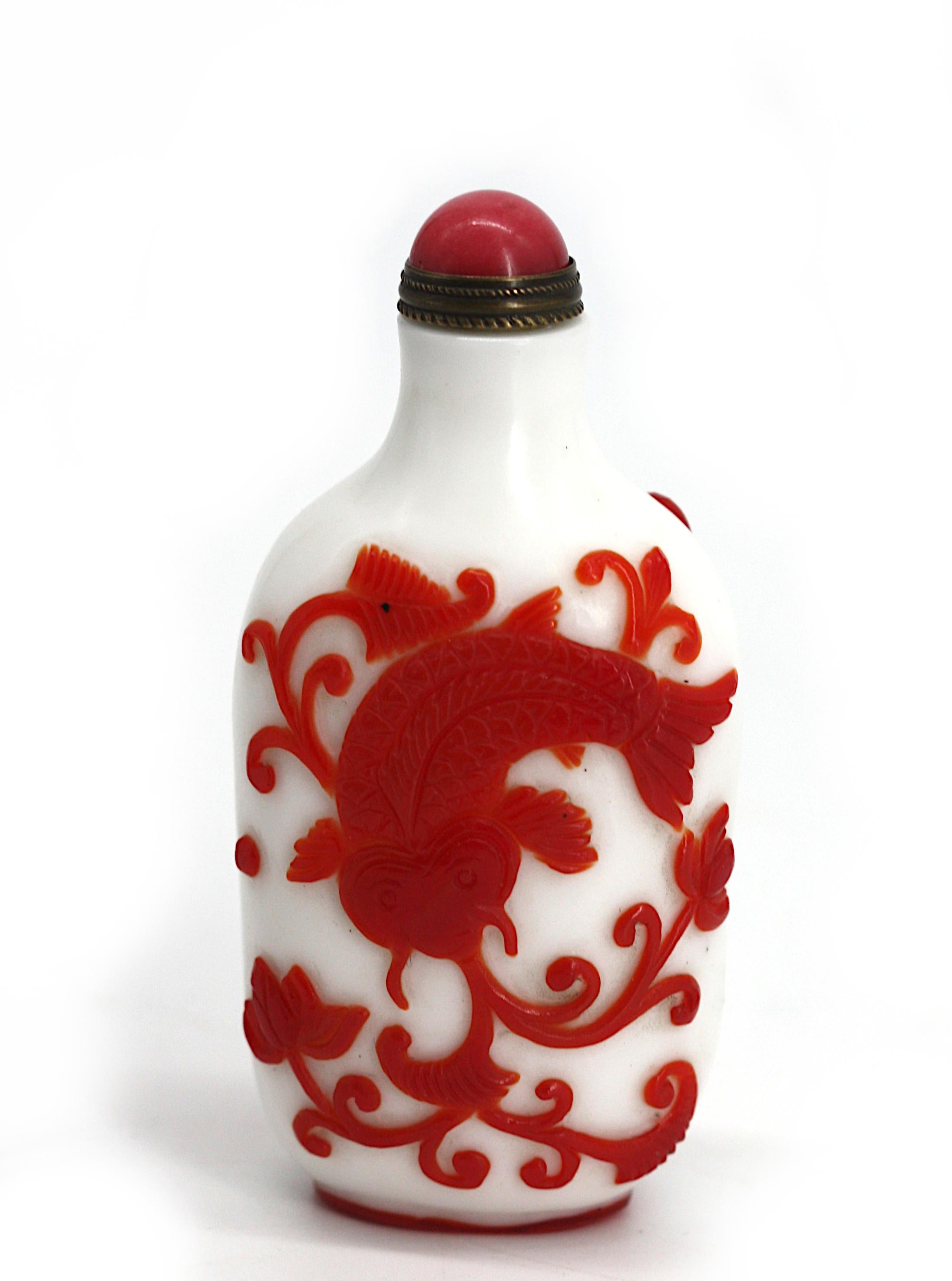 
Chinese Red Over White Peking Glass Snuff Bottle
The cylindrical body overlaid and carved with red carp and foliage, with a slightly raised foot, pink stone cap, with scoop.
Height 3 in.
Condition Report
Good condition.
