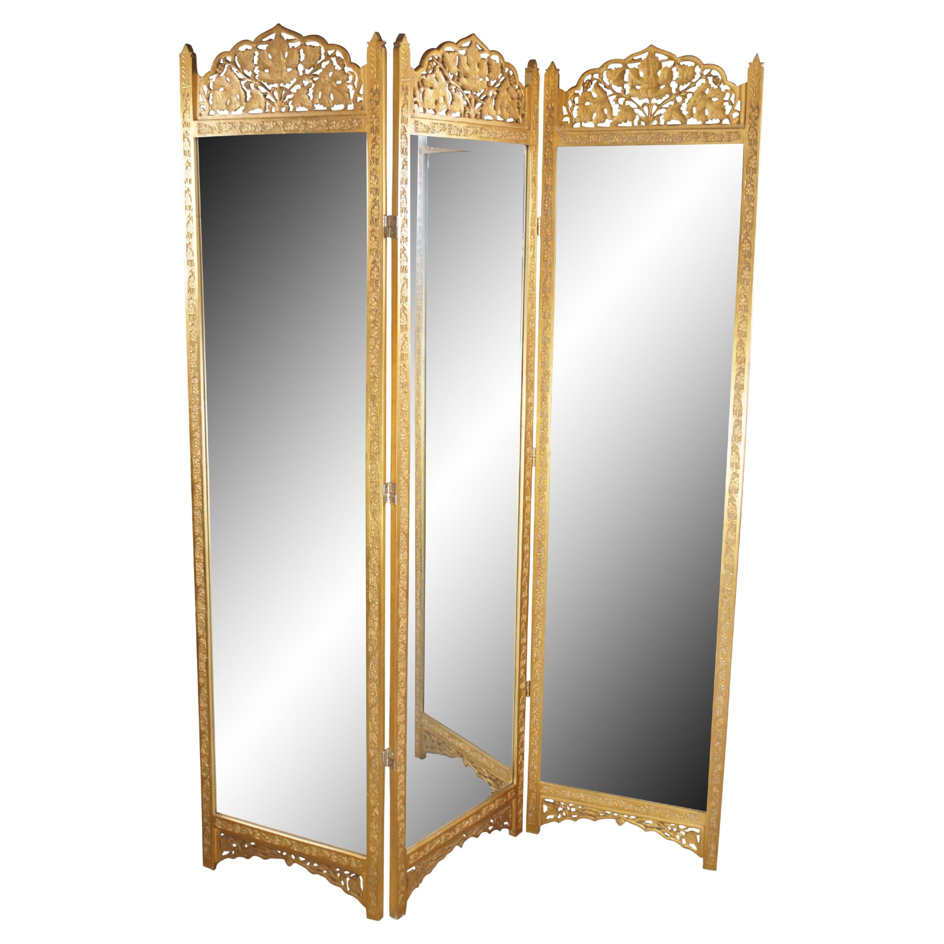 Vintage Chinese Chippendale / Hollywood Regency style gold giltwood tri fold full length dressing mirror / room divider featuring three double hinged beveled mirror panels with reticulated / pierced maple leaf and carved foliate