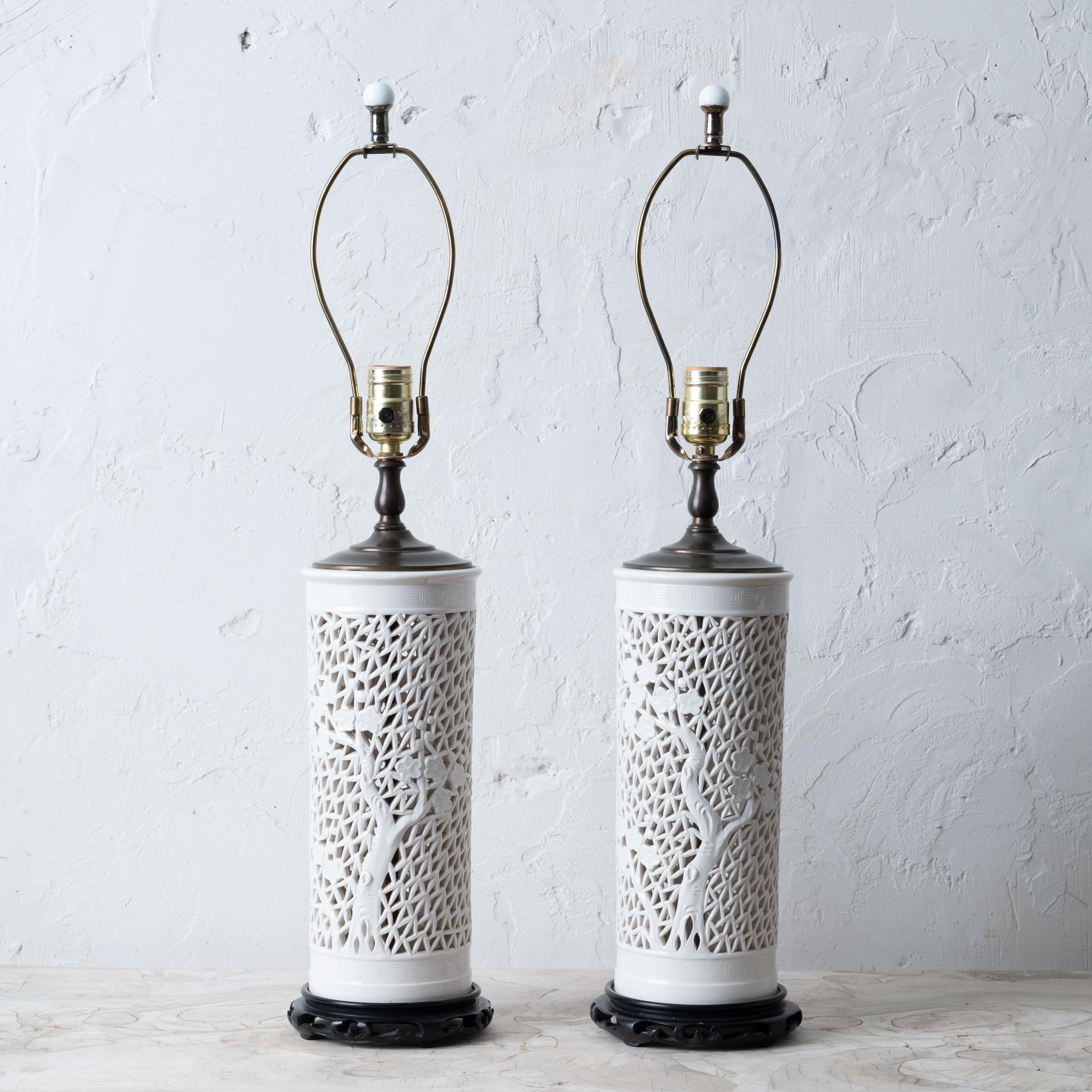 A pair of reticulated porcelain blanc de chine lamps, mid-20th century.

6 inches wide by 26 ½ inches tall; 13 ¼ tall porcelain base

