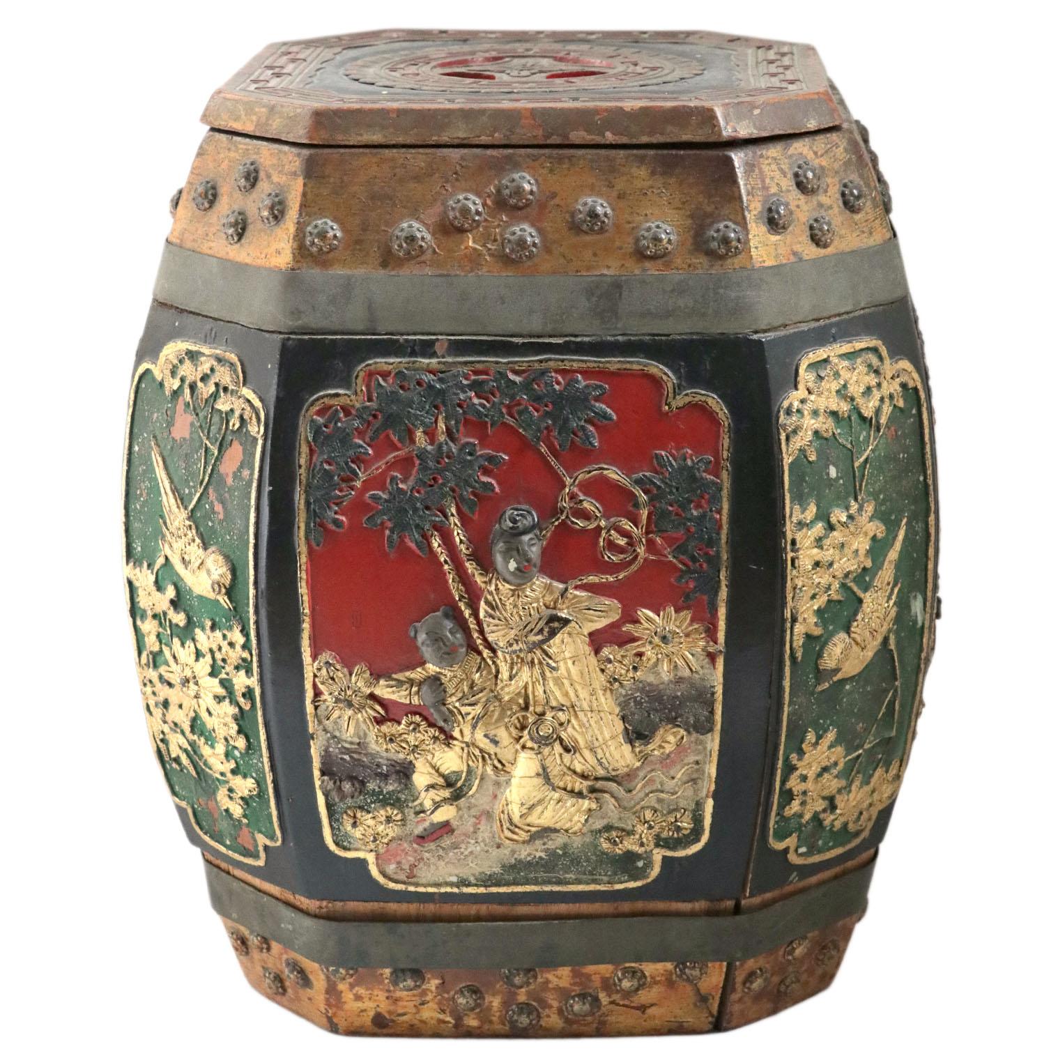 A decorative wooden Chinese rice barrel.