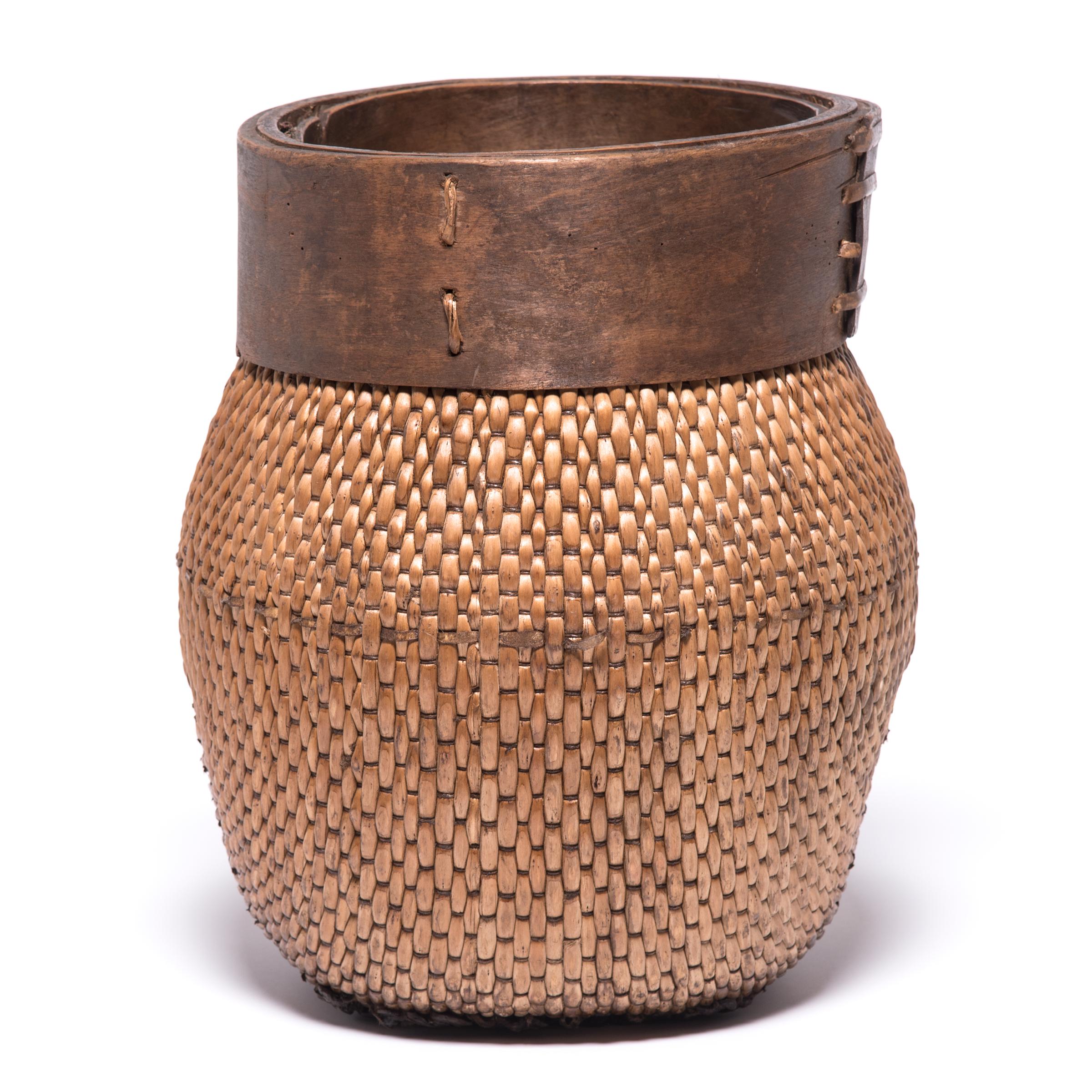 Centuries ago, a reed fisherman’s basket like this one would have been fairly common in rural China: an everyday item that would have been used until it was worn through. This particular example remains in beautiful condition and so a century later,