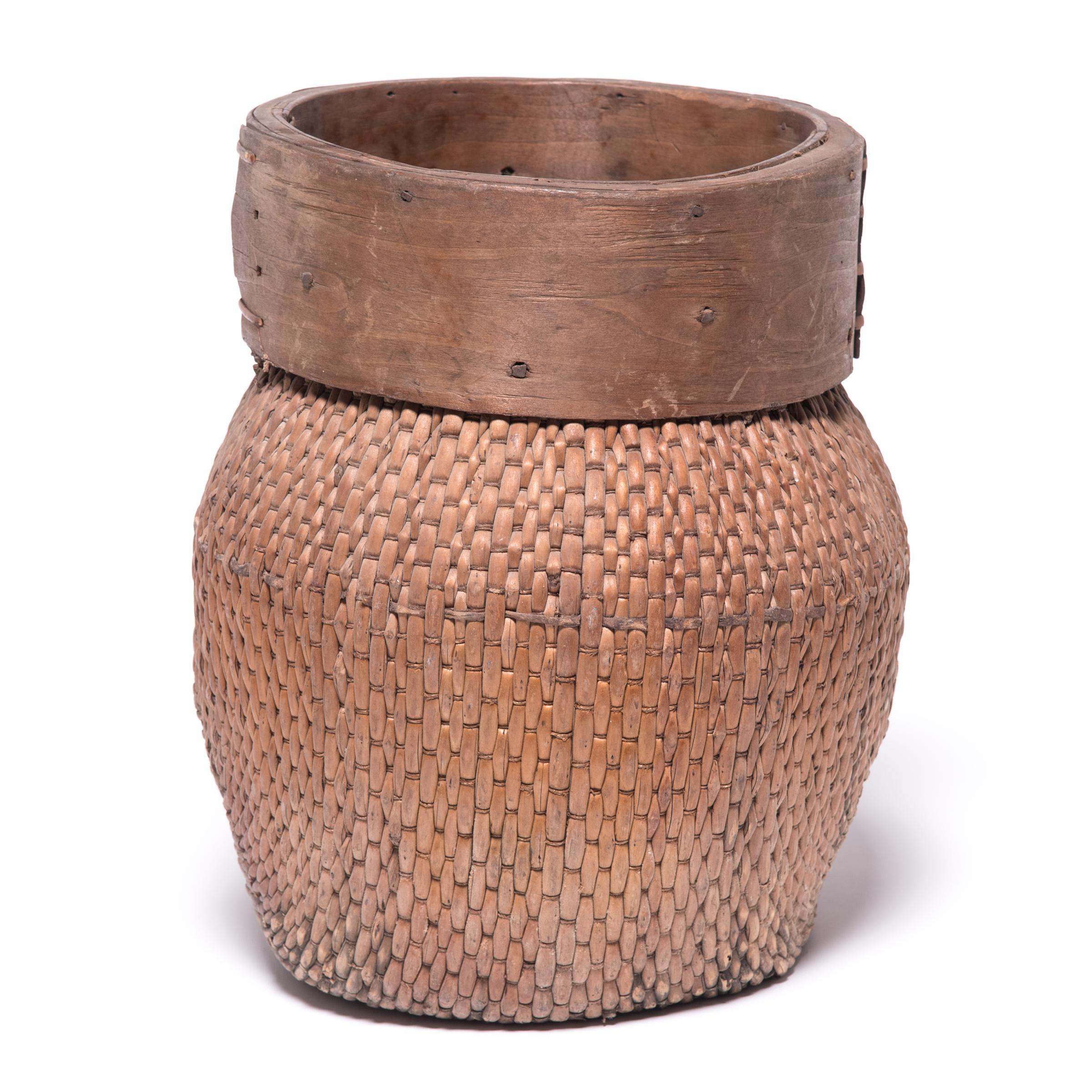 Centuries ago, a reed fisherman’s basket like this one would have been fairly common in rural China: an everyday item that would have been used until it was worn through. This particular example remains in beautiful condition, and so a century