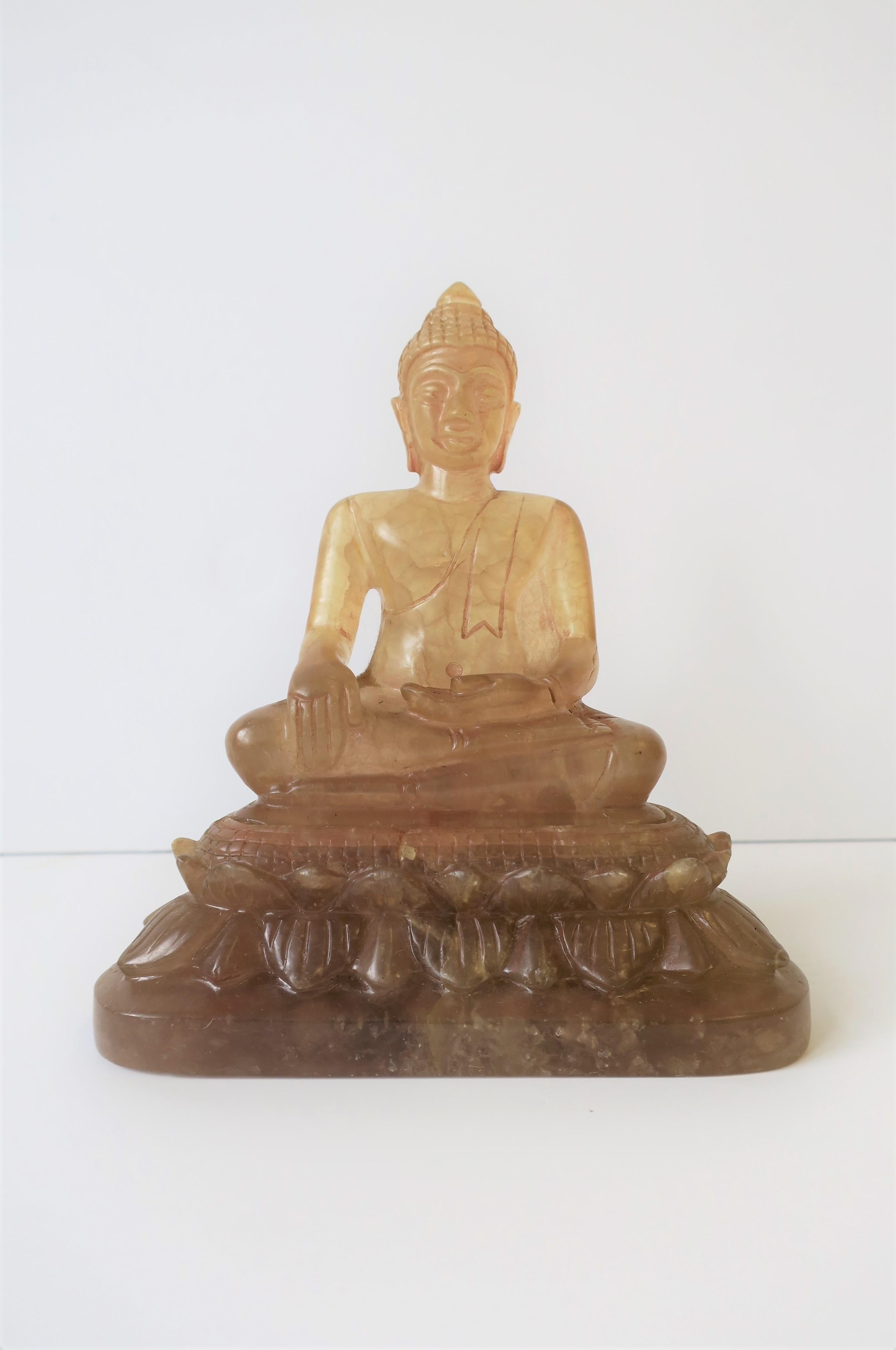 A beautiful carved rock crystal seated Buddha sculpture piece, circa 20th Century, China. Rock crystal Buddha has a light pink/rose/flesh-tone hue to it. Marked on base as show in image #14.

Piece measures: 3.5