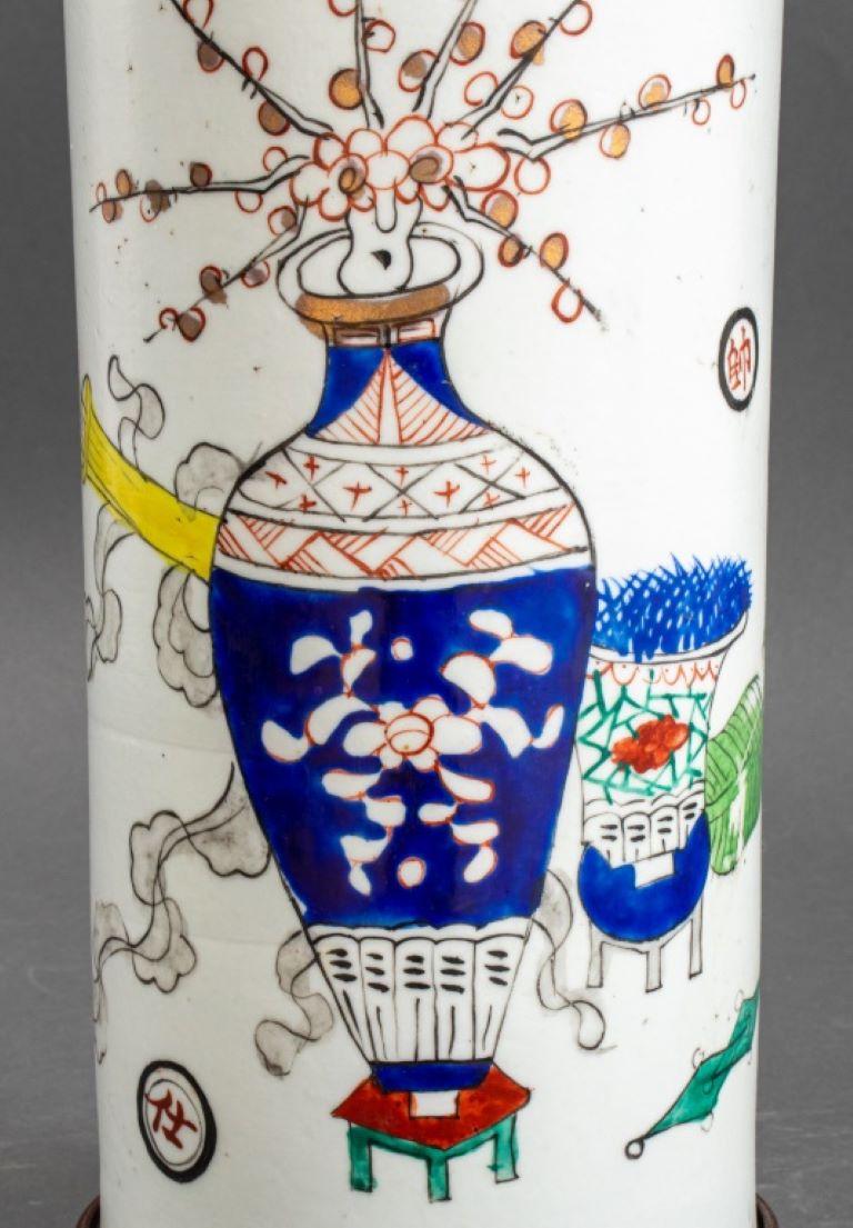 Chinese roll-shaped porcelain vase with still life decor now mounted as a table lamp raised on a wooden base.