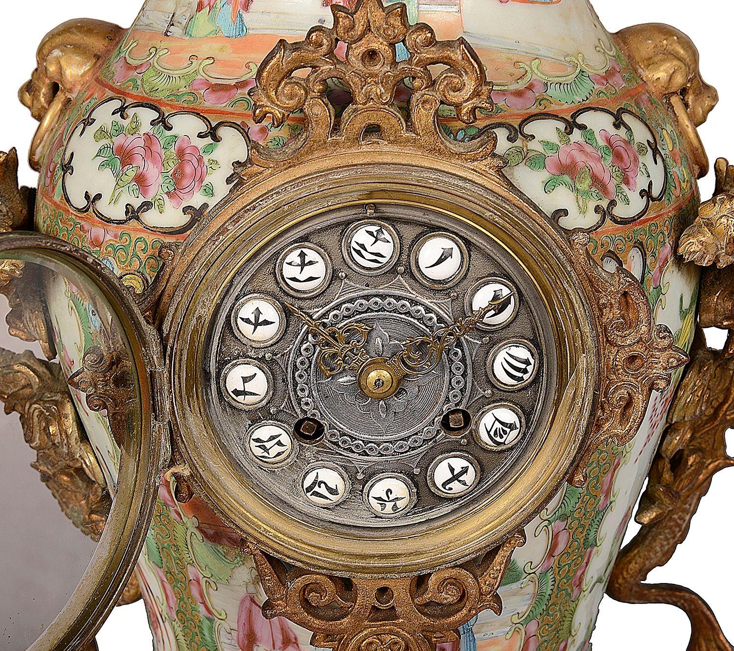 A very dramatic and decorative 19th Century Chinese Rose Medallion porcelain clock set. having wonderful gilded ormolu mounts, with mythical dragons handles and raised on hardwood style bases. The clock has an eight day striking hourly movement with