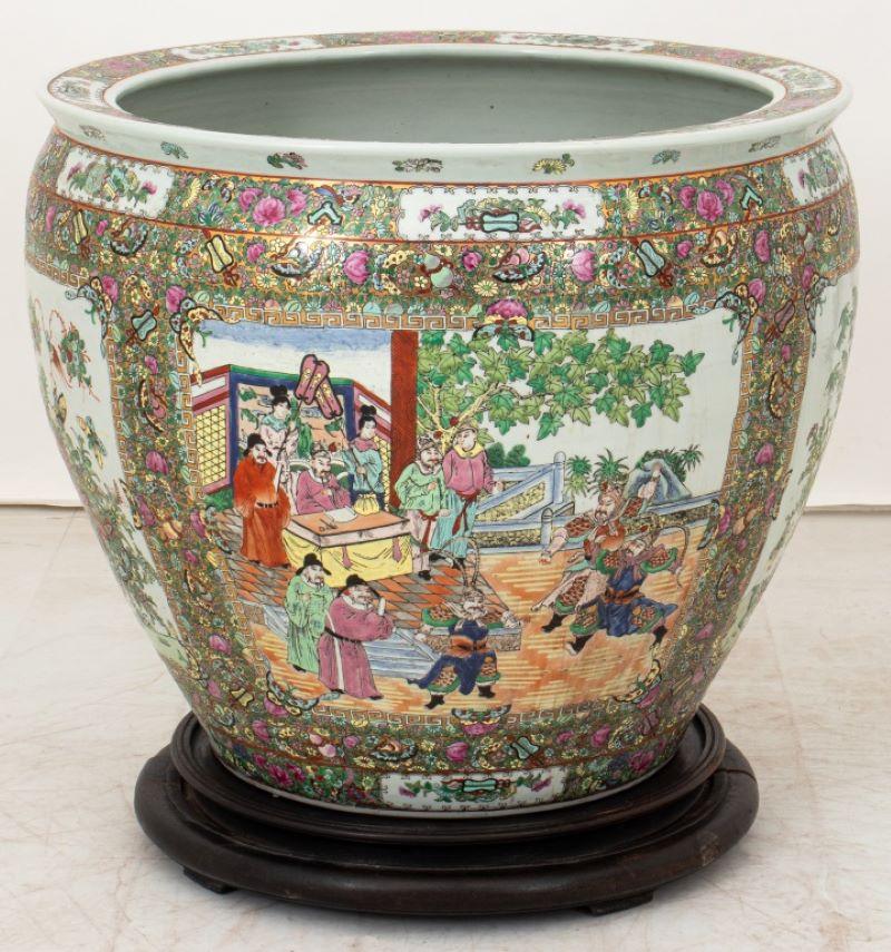 This Chinese Rose Medallion Porcelain Fishbowl features detailed scenes of court life, with figures in traditional clothing amidst pavilions, gardens and floral scenes. There is a six figure overglaze mark to underside. Dimensions: 22