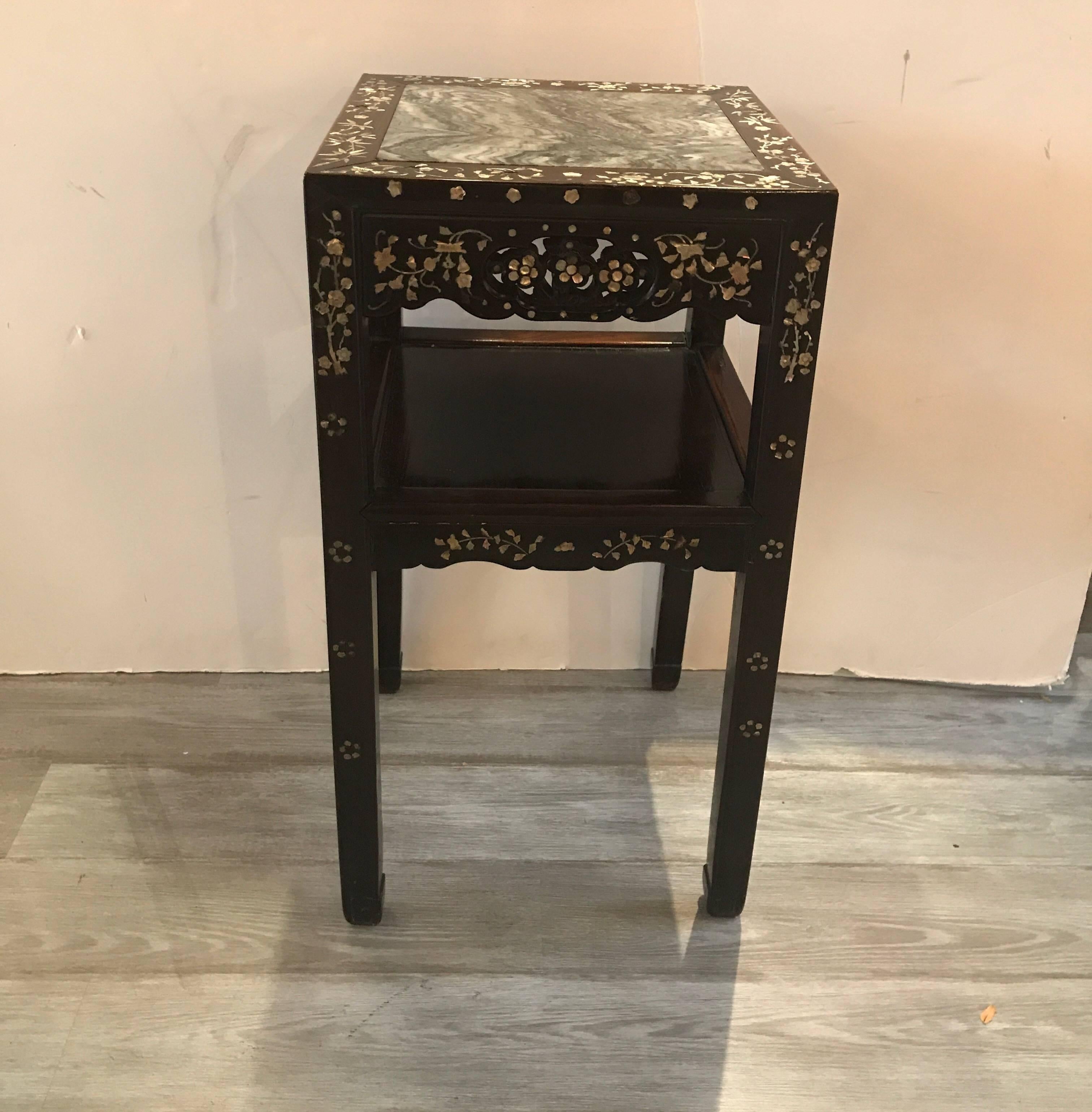 Rare 19th century Chinese rosewood stand with shelf. The rosewood with intricate inlays of mother of pearl all-over. The top is an unusually wavy gray and darker gray stone called dream stone. The frames has some shrinkage and shows some normal