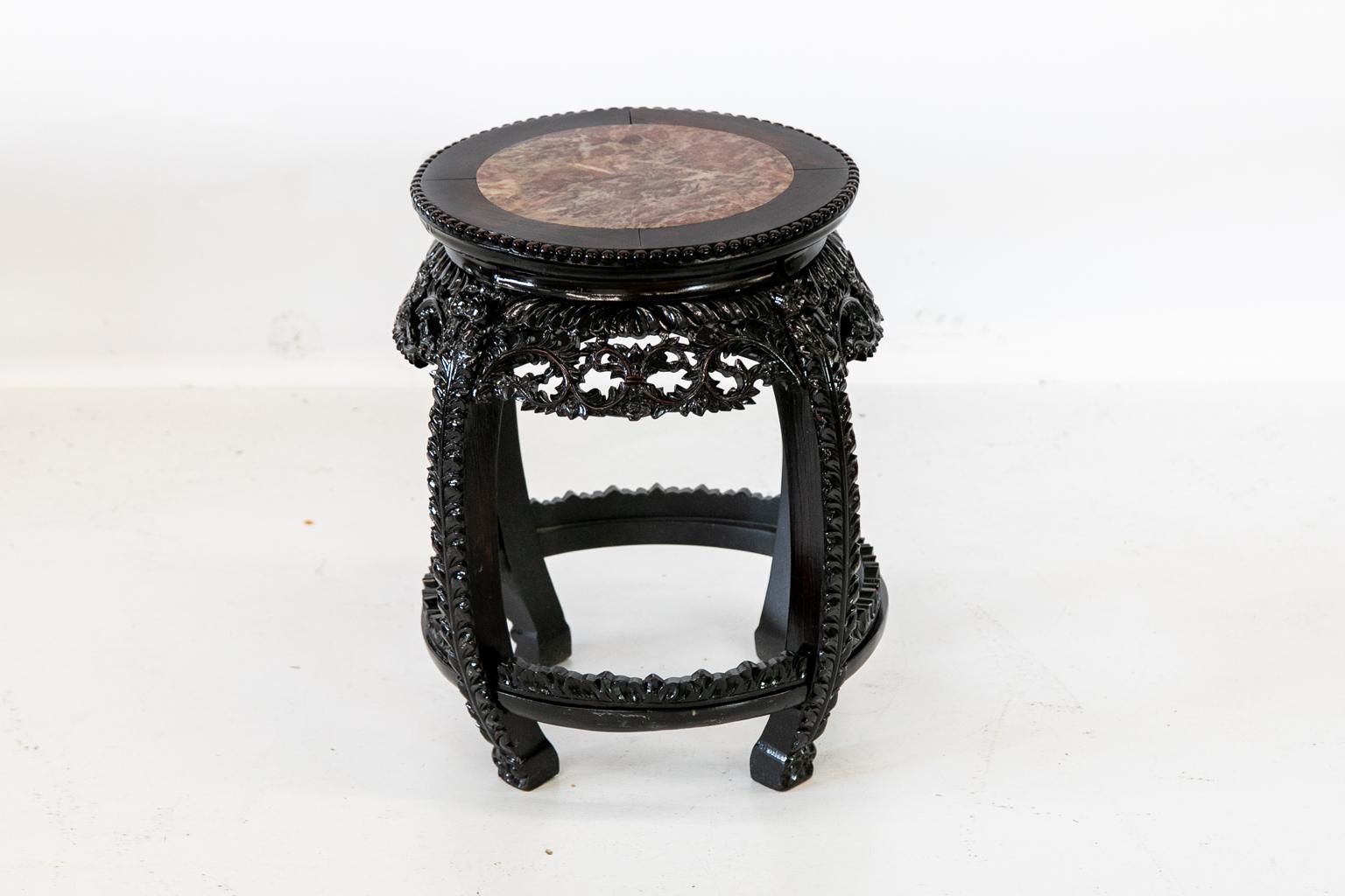 Chinese rosewood carved stand is carved with leaves and has a beaded edge around the top. The arched legs are carved, and the marble center is original.