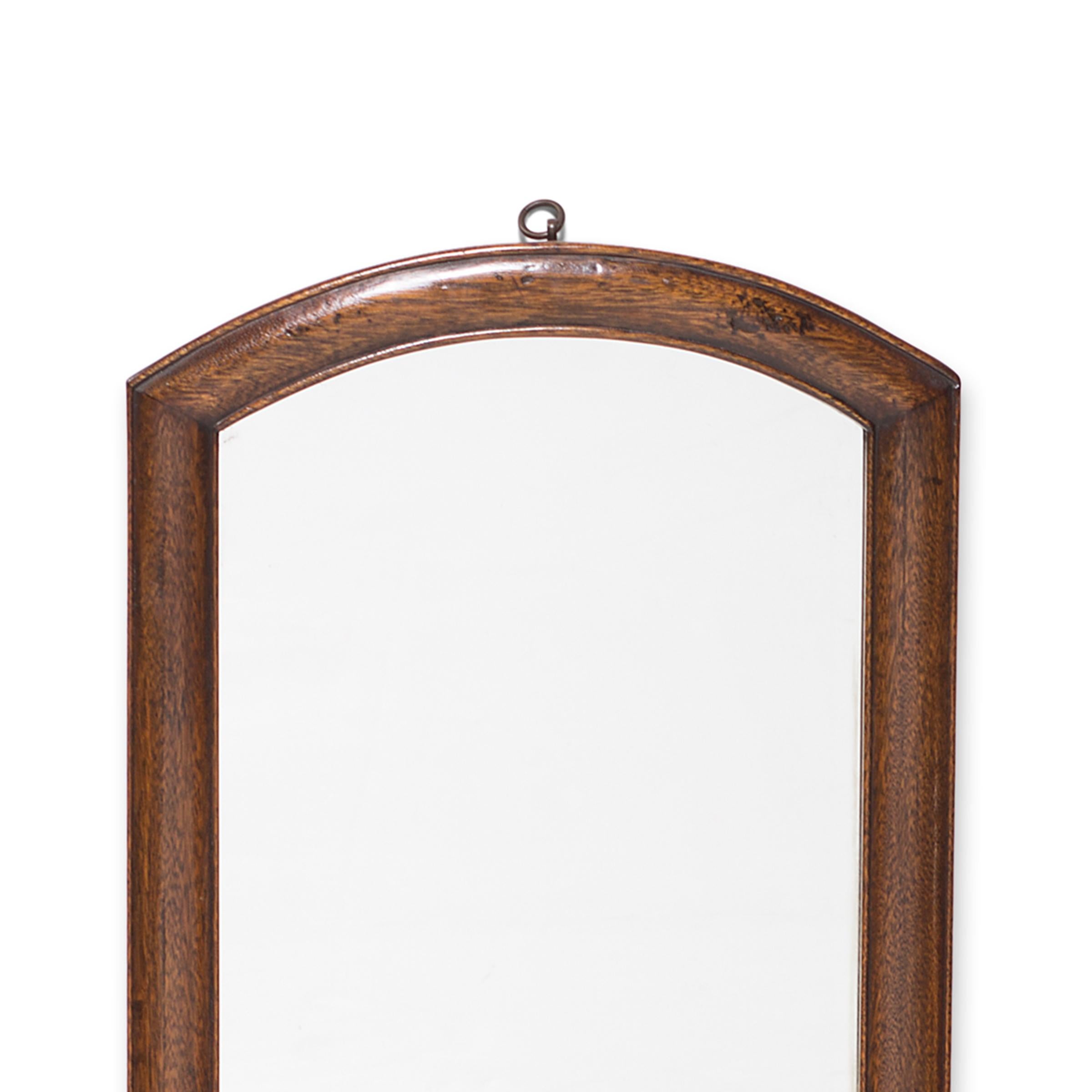 This Art Deco wall mirror from Shanghai, China is framed in a fine hardwood valued for its tight grain and warm coloring. The influence of Western aesthetics in the early 20th century is apparent in the modern geometry of its deceptively simple