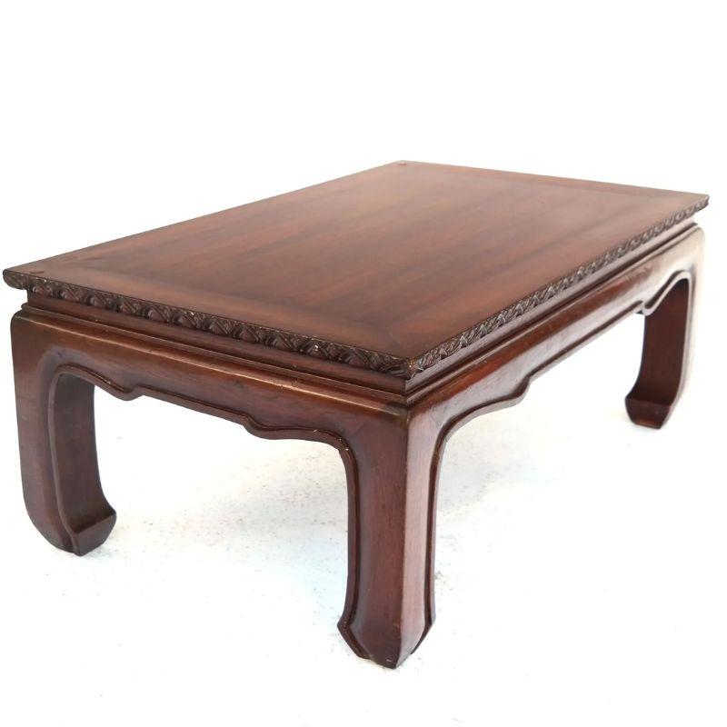 Vintage Chinese rosewood coffee table, Mandarin style with carved frieze detail, curved apron and legs, and a glass top.
