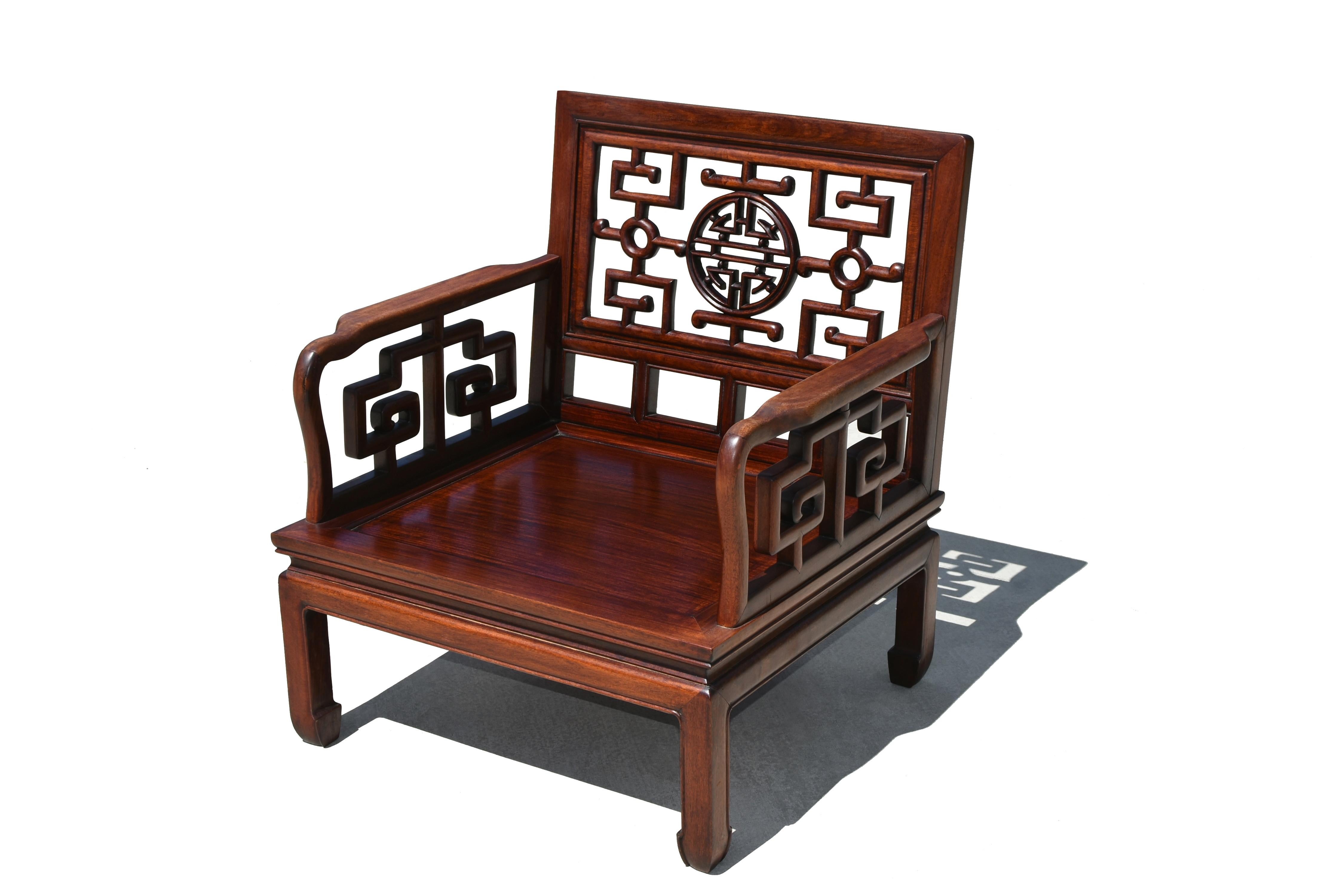 One beautiful solid rosewood meditation chair of the highest quality. Solid construction with tenons and mortises. Back splat finely carved with longevity motifs centered around the medallion of long life. Arms solid and comfortably contoured, with