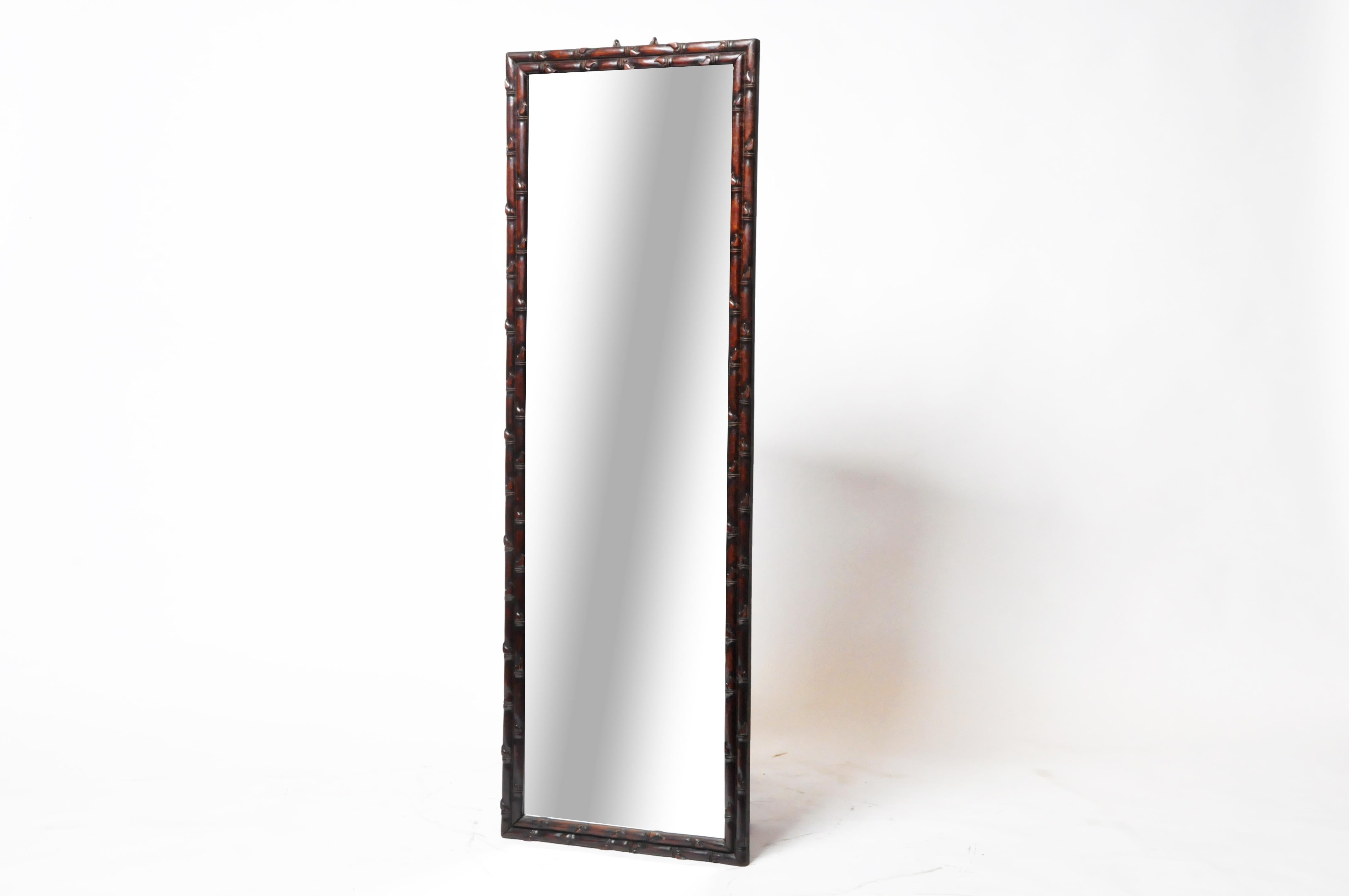 This mirror frame was made in Rangoon from rosewood and carved in a subtle bamboo pattern. The mirror was part of a series found in a Chinese-Burmese home. During the British Colonial period, many Chinese immigrated to Burma from Guangdong Province