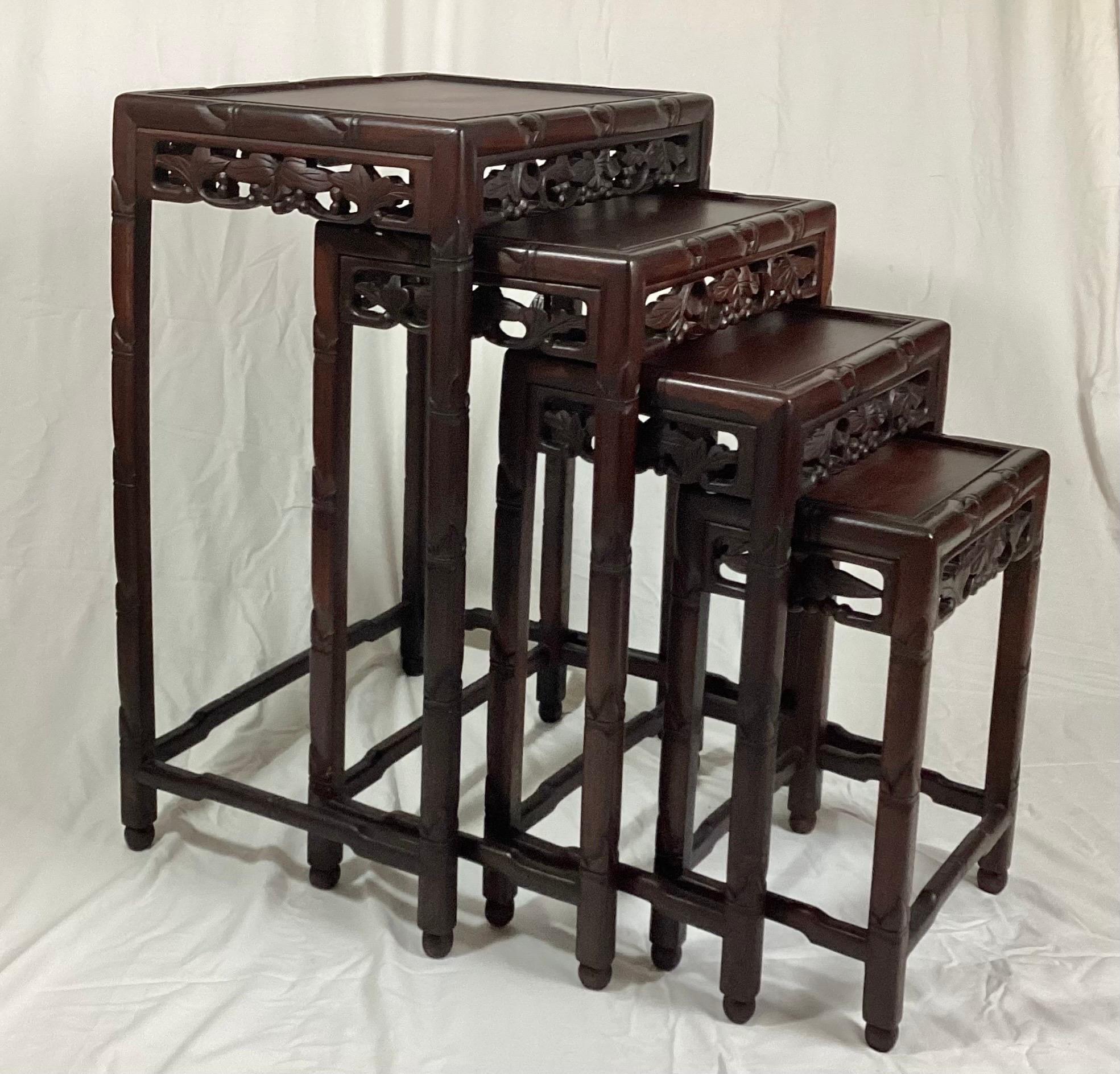 Chinese Rosewood set of 4 nesting tables with carved Frieze Decoration. The largest is 14