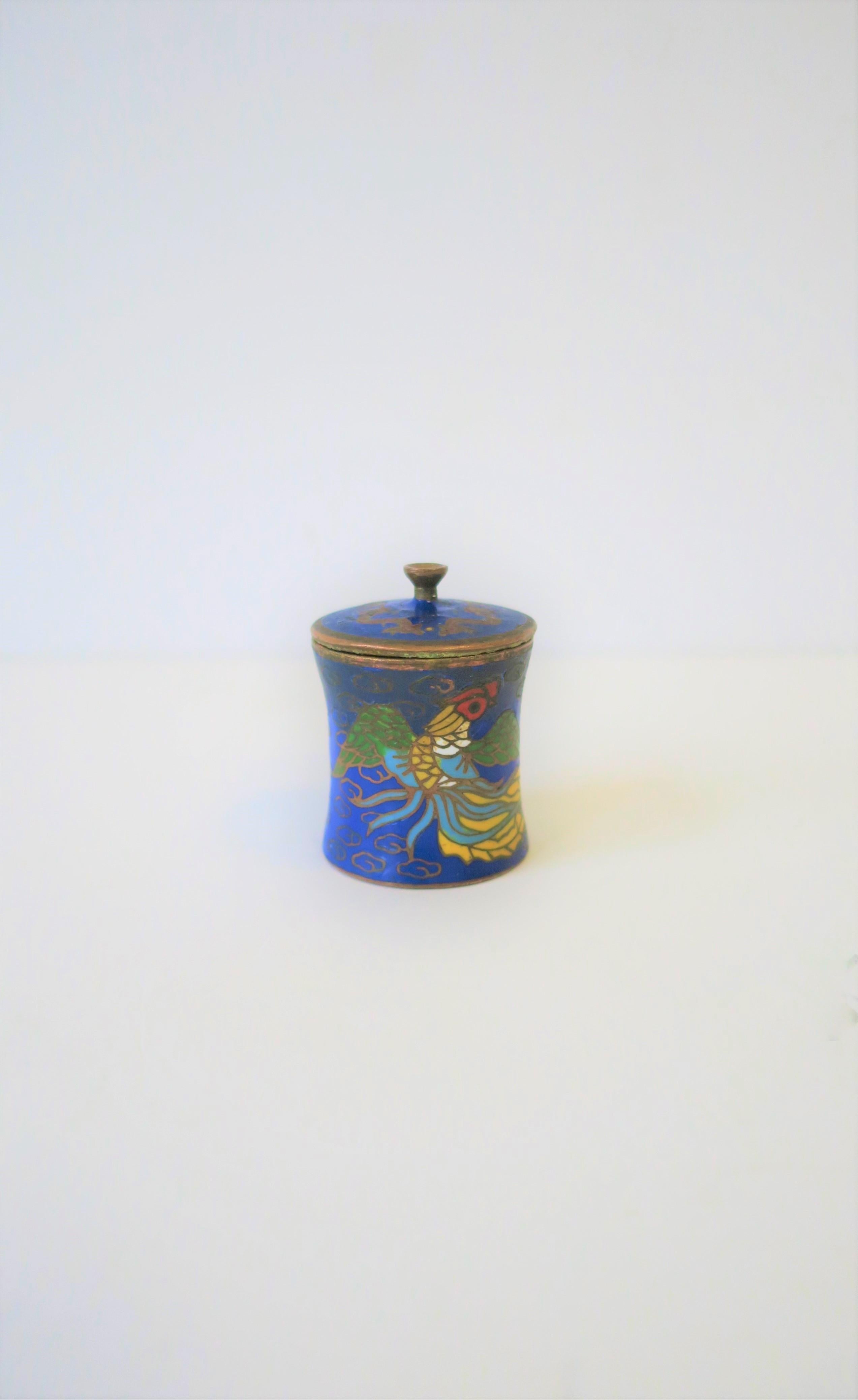 A beautiful, small, detailed round Chinese Cloisonné enamel and brass box with lid, circa mid to early 20th century China. This is a great petite box with a beautiful 'squid' sea creature exterior design that wraps around; box is predominantly blue