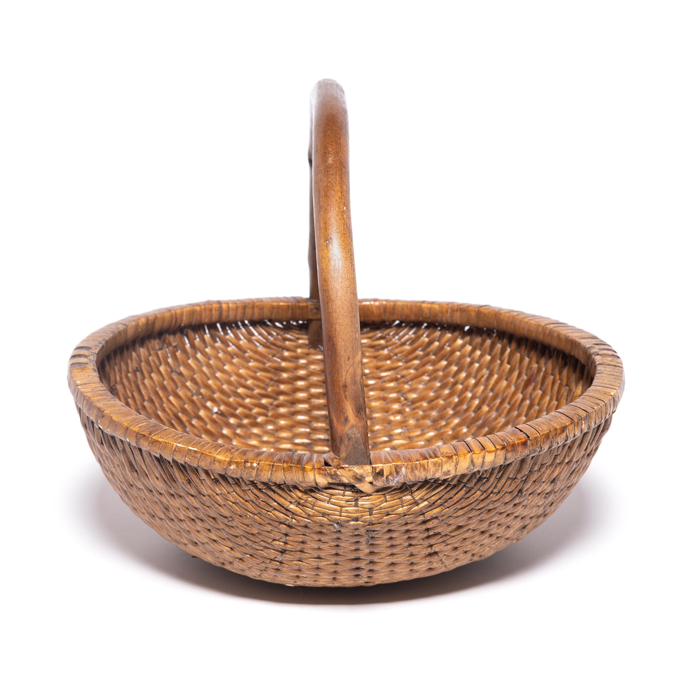 This basket was made in Southern China over a century ago by a skilled artisan with many years of training. It was common to learn the skill from a father or older family member: the knowledge passing from generation to generation. This basket has a